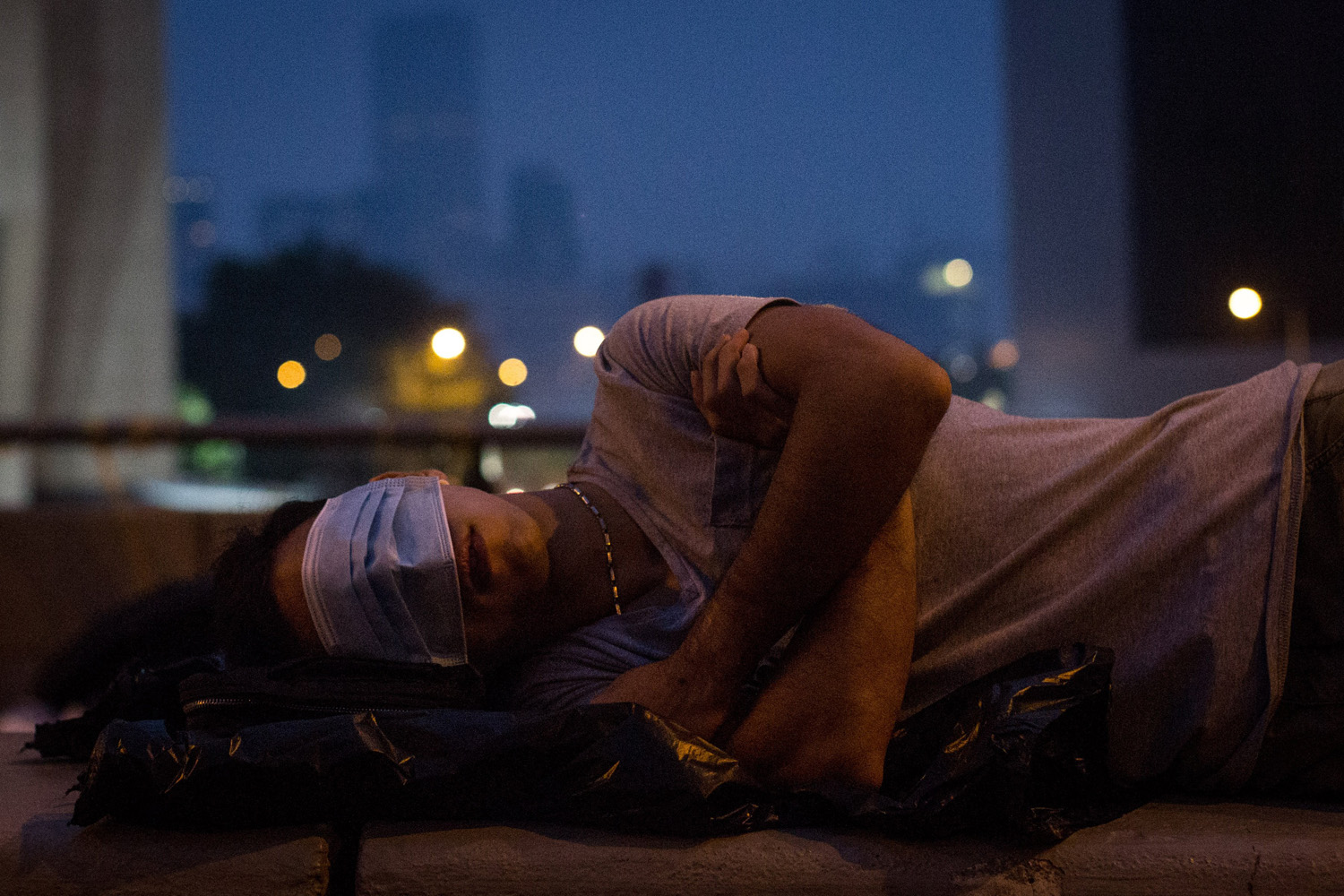 A pro-democracy protester sleeps on a concrete road divider on a street outside the Hong Kong Government Complex on Oct. 5, 2014 in Hong Kong, Hong Kong.