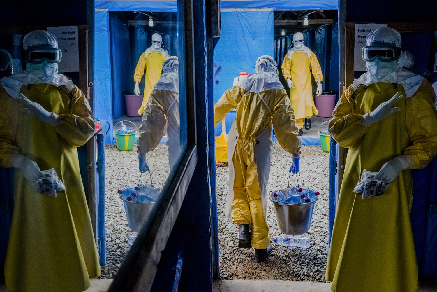 Health workers enter the high-risk zone as they make the morning rounds at the Bong County Ebola Treatment Unit in Sgt. Kollie Town near Gbarnga, Liberia, Oct. 6, 2014.