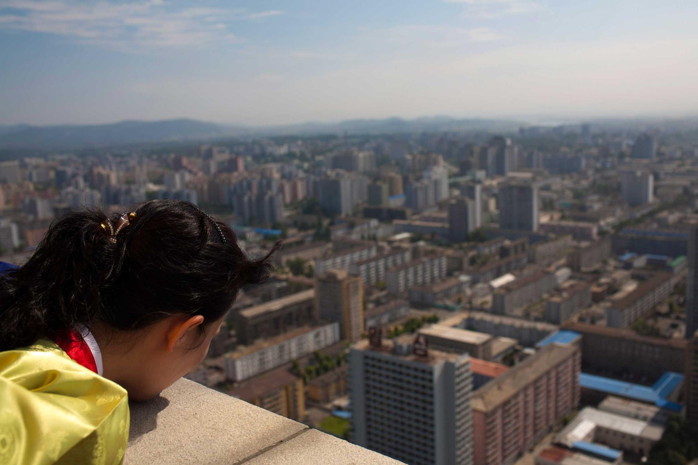 Aug. 26, 2011. A North Korean woman looks down at the city of Pyongyang from the top of the Tower of the Juche Idea.