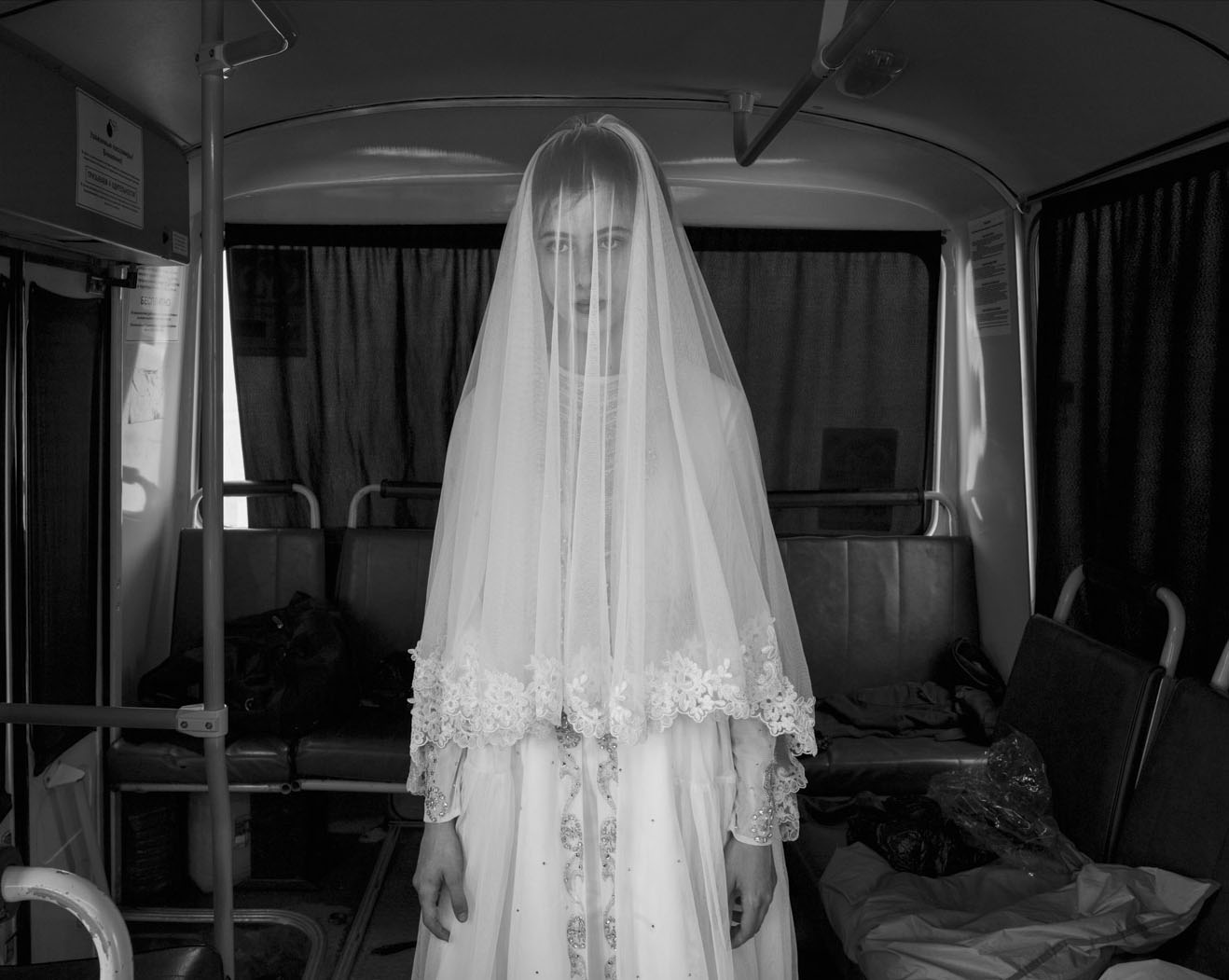 Rada, 14, tries on a wedding dress. Chechnya. 2013.