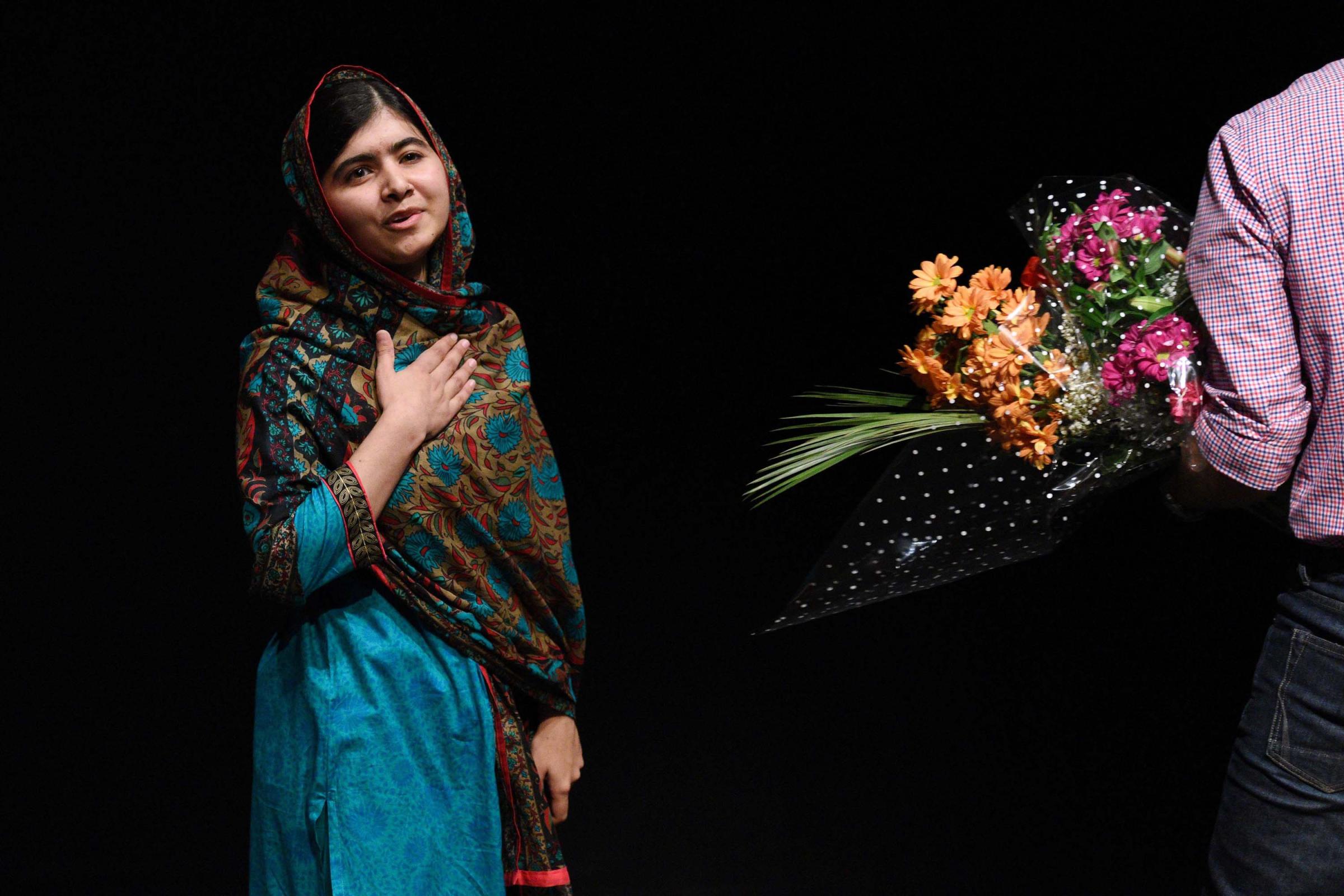 The Nobel Peace Prize went to 17-year-old Pakistani Malala Yousafzai and India's Kailash Satyarthi for their work promoting children's rights. Yousafzai gestures after addressing the media in Birmingham, central England on Oct. 10, 2014.