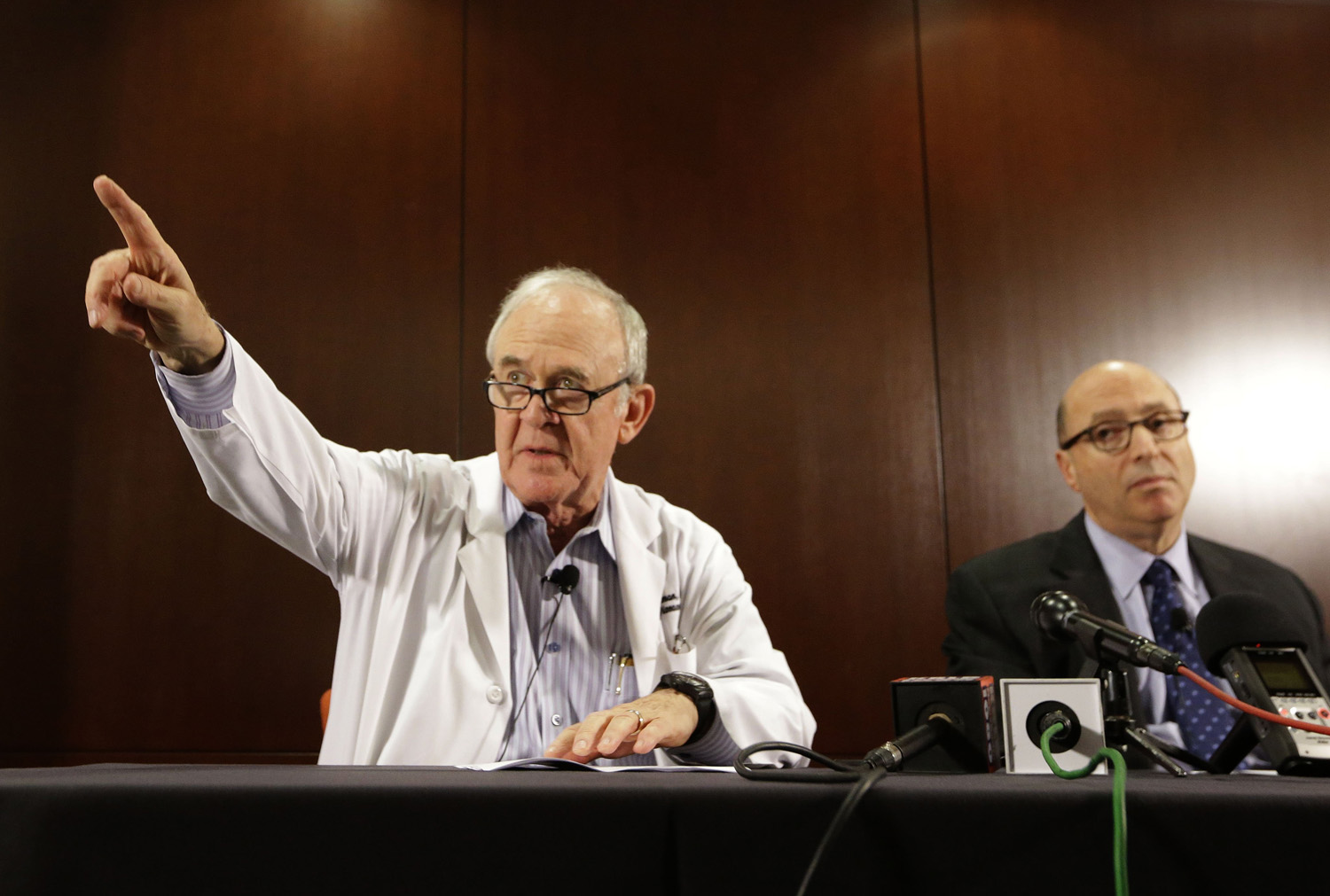 Dr. Edward Goodman, left, epidemiologist at Texas Health Presbyterian Hospital Dallas, points to a reporter for a question as Dr. Mark Lester looks on during a news conference about an Ebola infected patient they are caring for in Dallas, Sept. 30, 2014. (LM Otero—AP)