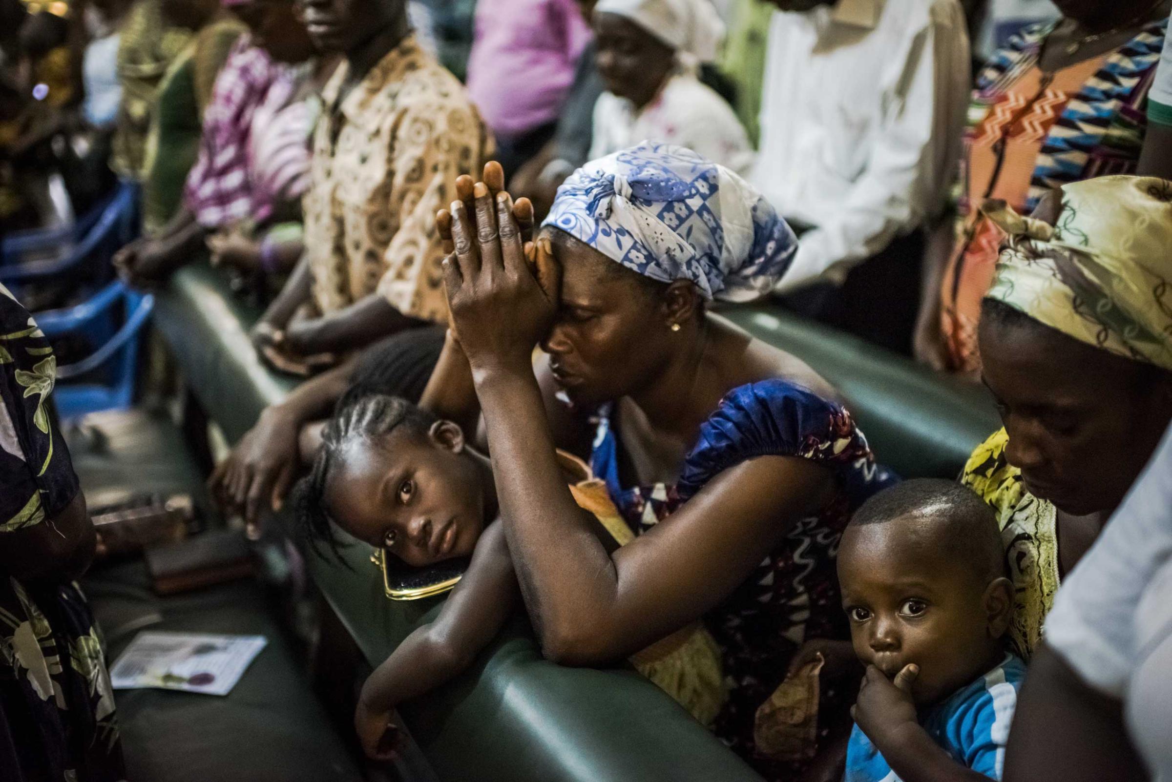 Residents of the West Point neighborhood attend church after a 10-day quarantine was lifted in Monrovia, Liberia.