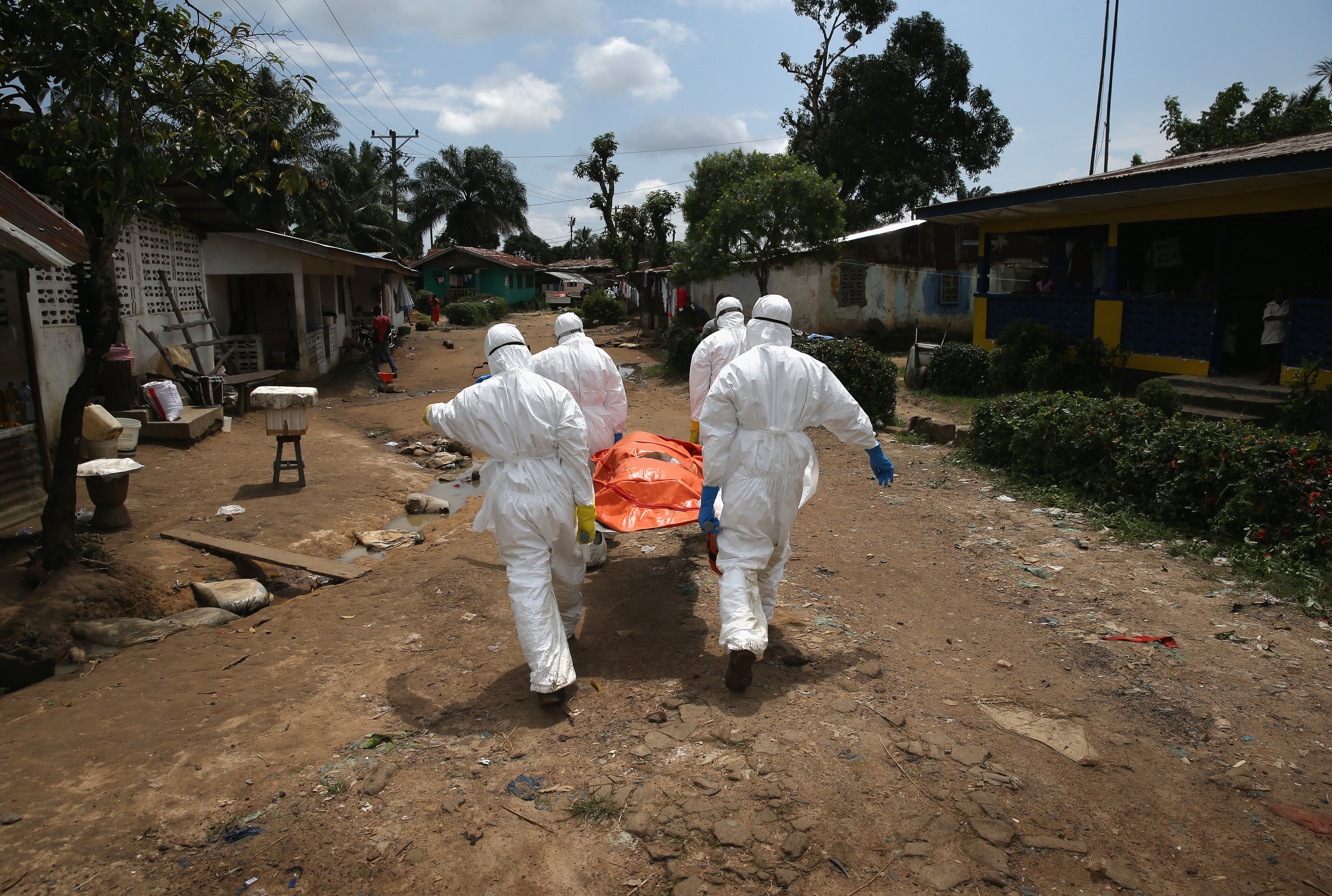 An Ebola burial team carries the body of a woman through the New Kru Town suburb on Oct. 10, 2014 of Monrovia, Liberia. (John Moore—Getty Images)