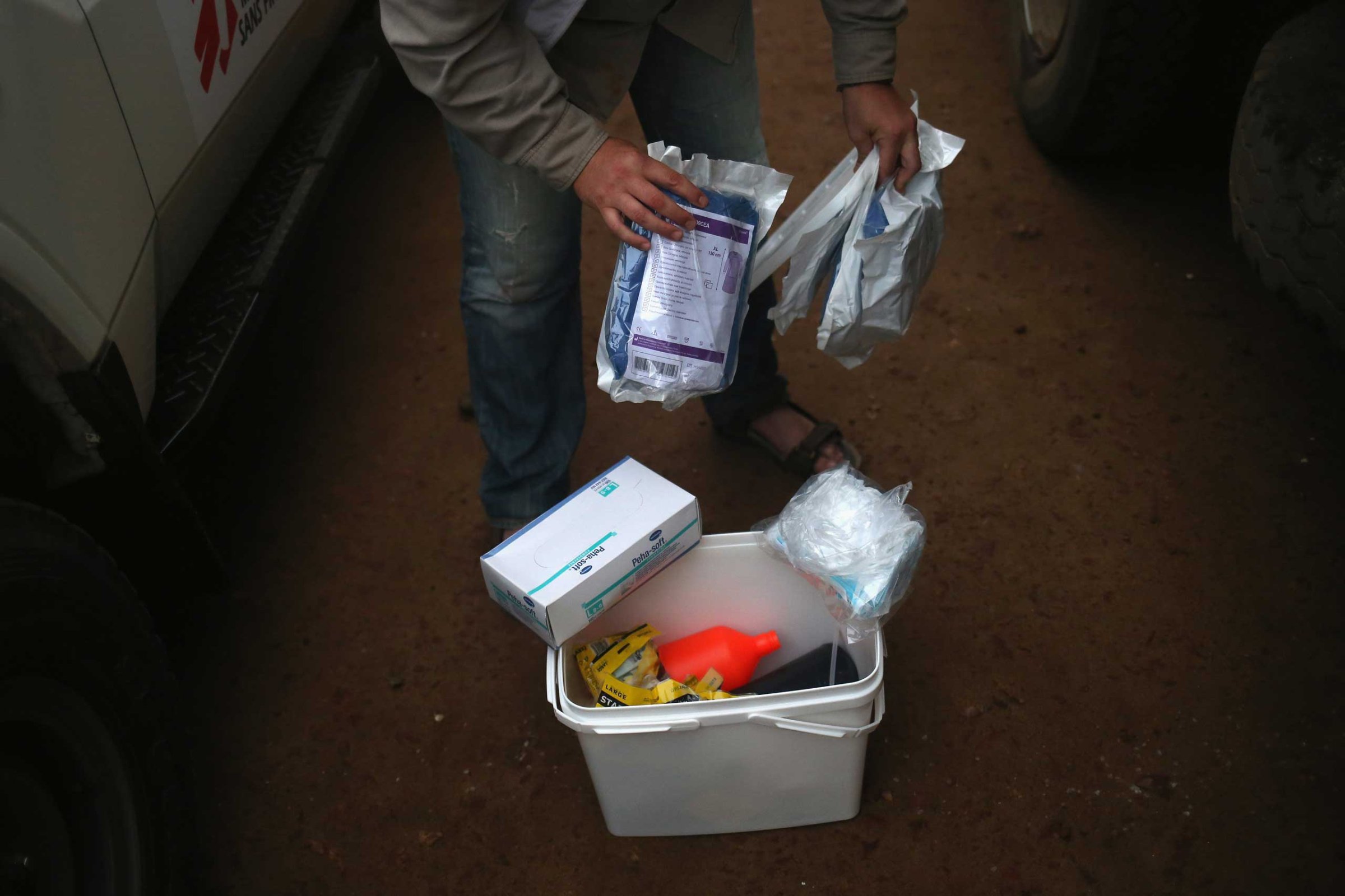 A Doctors Without Borders, worker displays a family and home disinfection kit which MSF distributed on Oct. 4, 2014 in New Kru Town, Liberia.