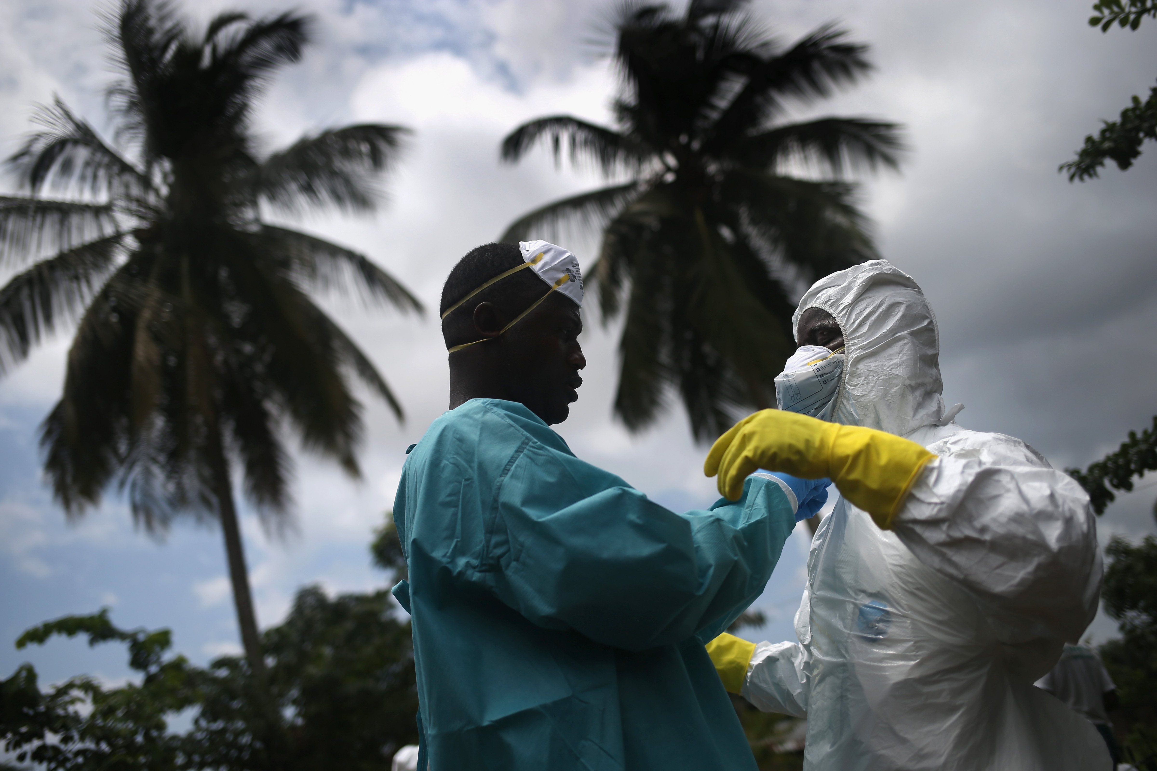 An Ebola burial team dresses in protective clothing before collecting the body of a woman from her home in the New Kru Town suburb of Monrovia, Liberia on Oct. 10, 2014 (John Moore—Getty Images)