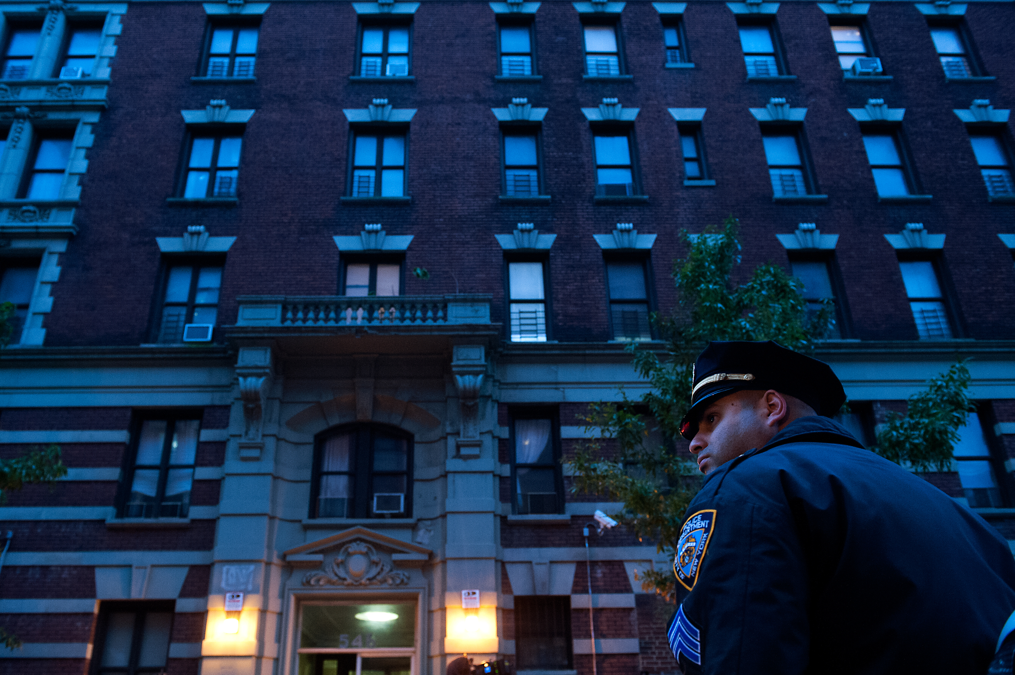 Police officers stand outside 546 W. 147th street, the apartment building of Dr. Craig Spencer on Oct. 23, 2014 in New York City.