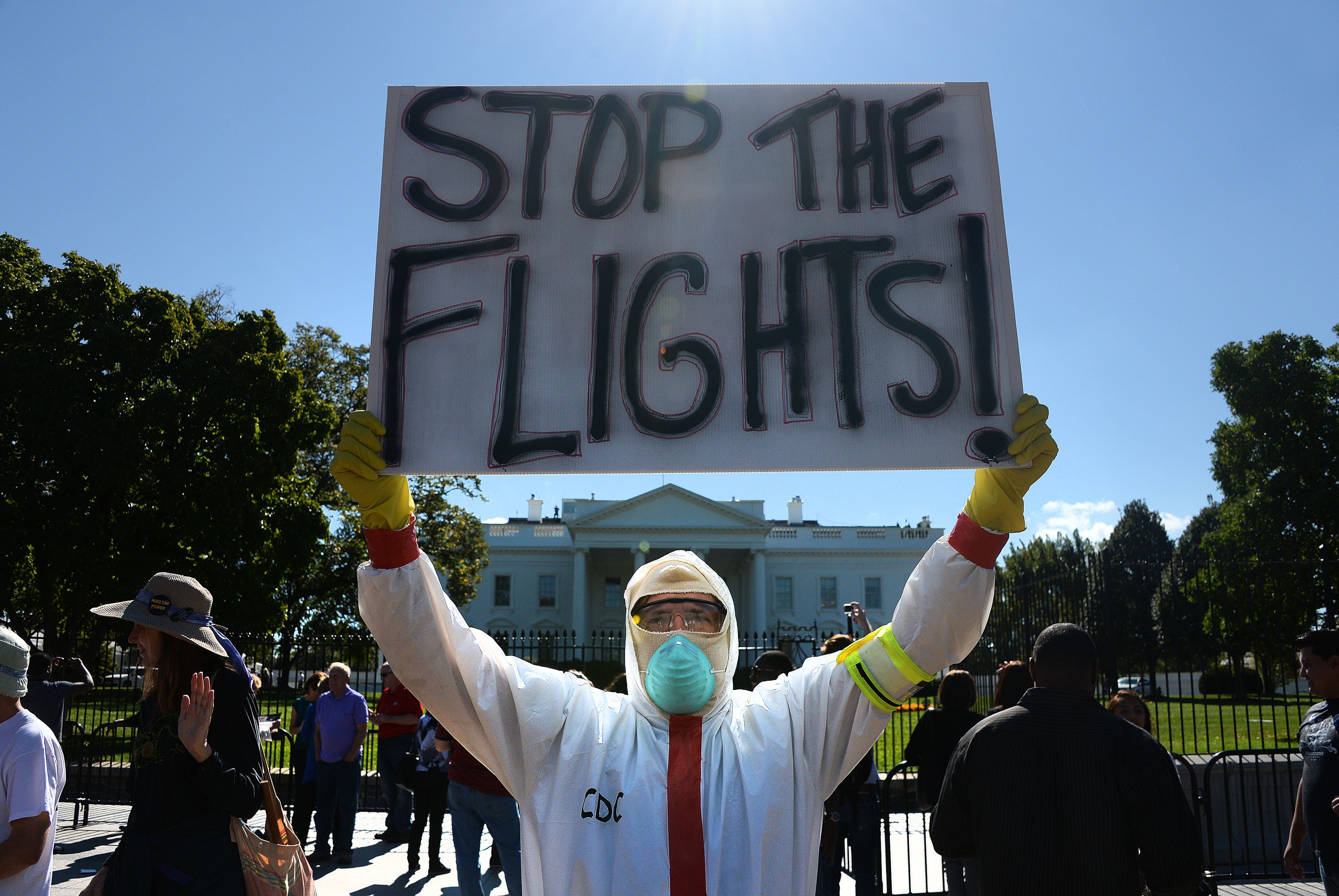 A protester stands outside the White House asking President Barack Obama to ban flights in effort to stop Ebola on Oct. 17, 2014 in Washington, DC. (Olivier Douliery—dpa/Corbis)