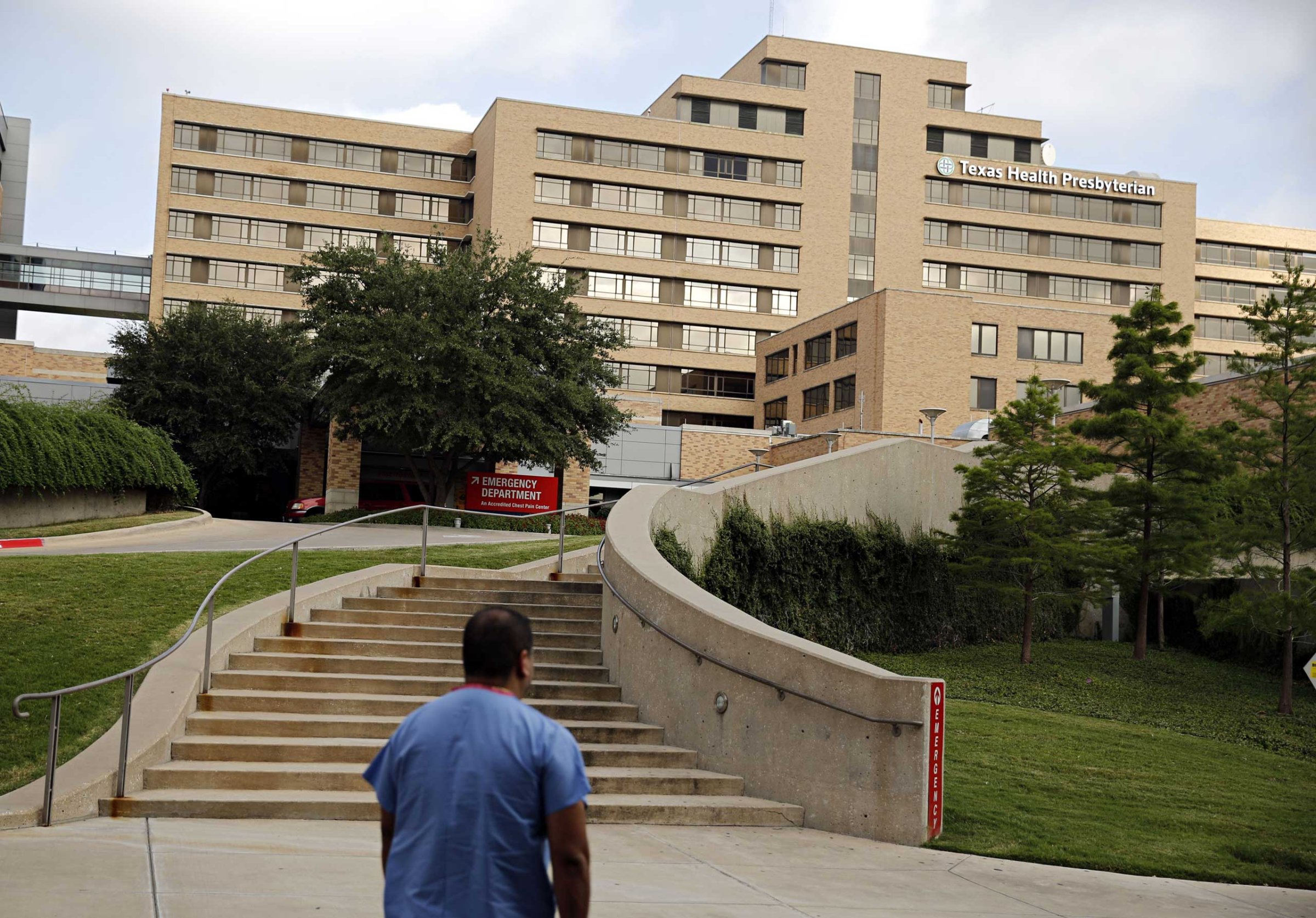 A hospital staffer walks up to the emergency room at Texas Health Presbyterian Hospital, Oct. 1, 2014 in Dallas.