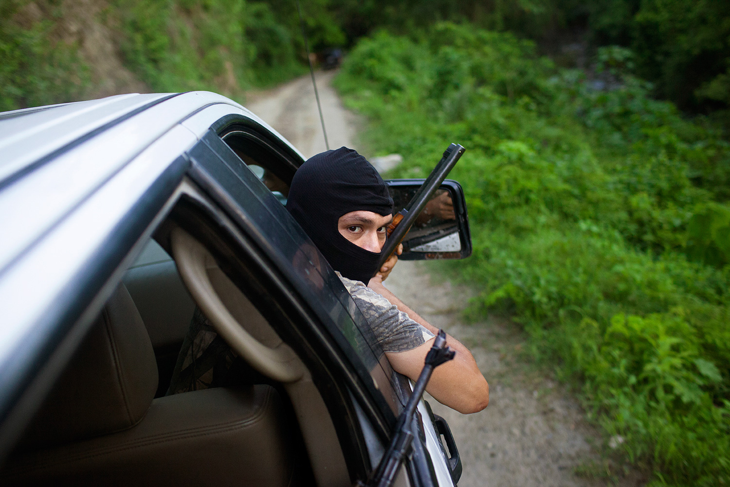A member of an autodefensa group patrols a mountain road, Michoacán, Mexico, July, 2013.