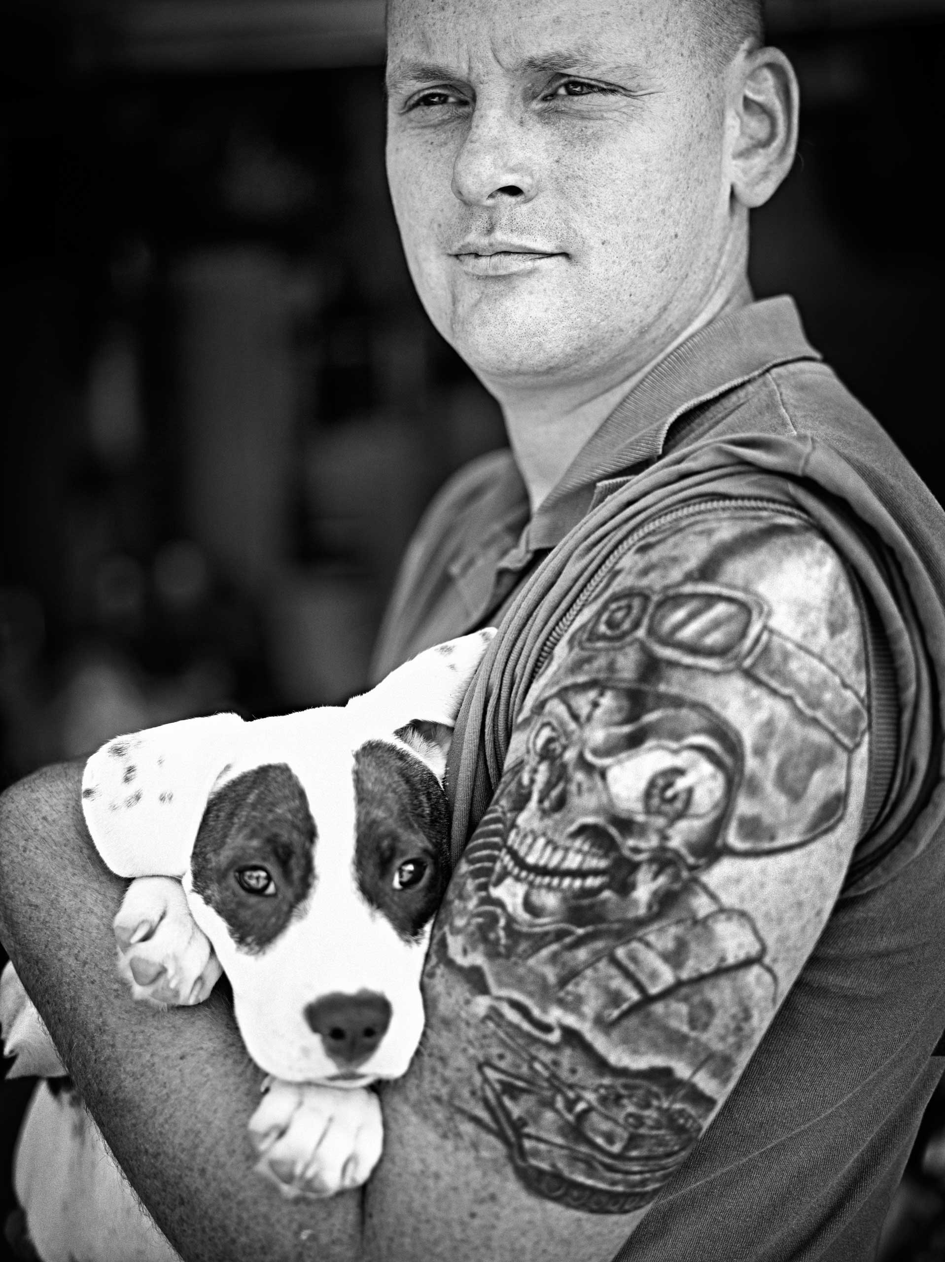 US Army Veteran Steve Moore poses for a photograph with Snickers, a young puppy he adopted, in front of his home in Santa Rosa, California, United States on September 30, 2014.
                              
                              Moore served in the US Army for four and a half years and did two tours in Iraq with Dragon Company, 1st Squadron, 3rd Armored Cavalry Regiment.