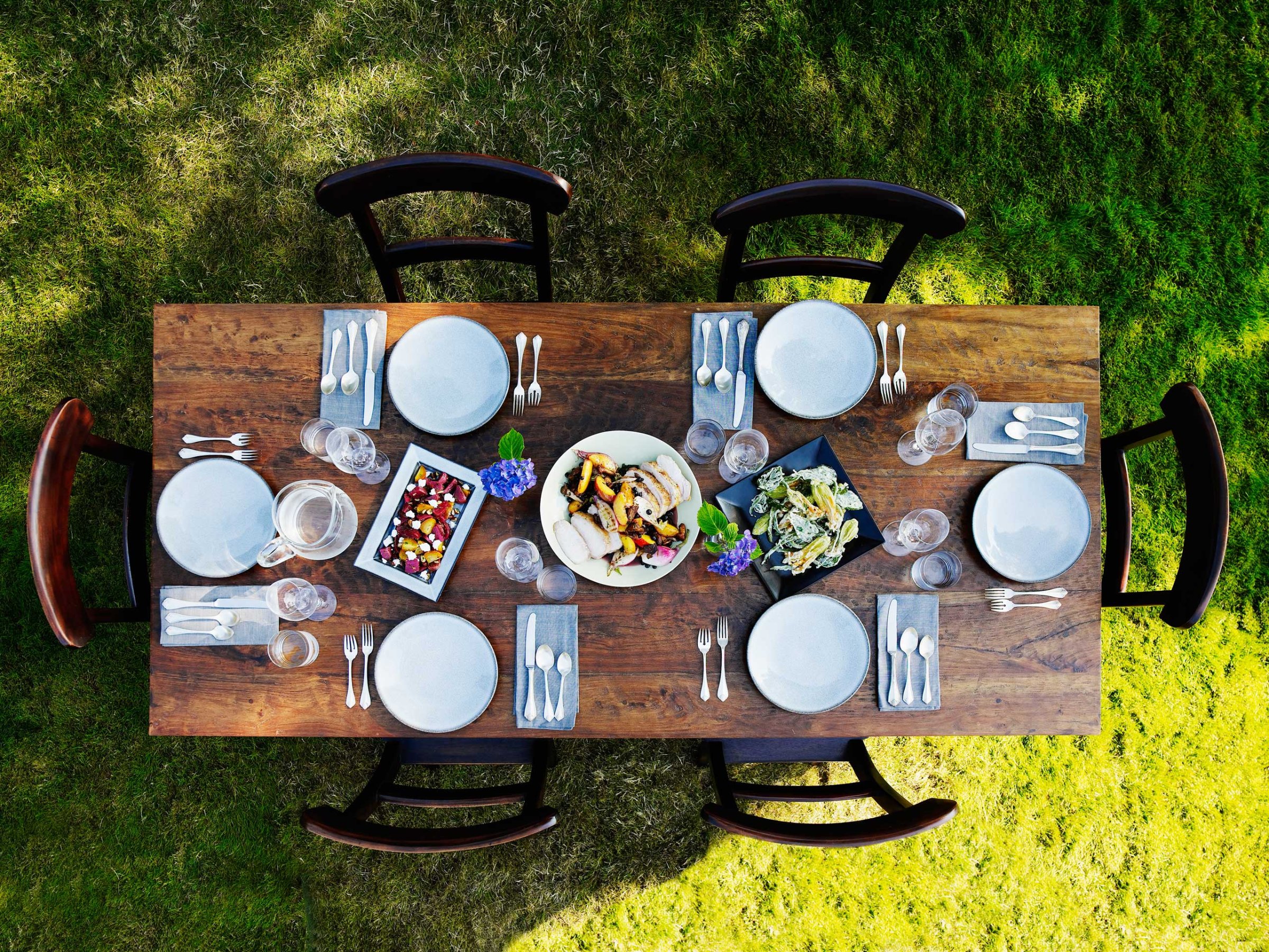 Set dinner table outside on grass lawn