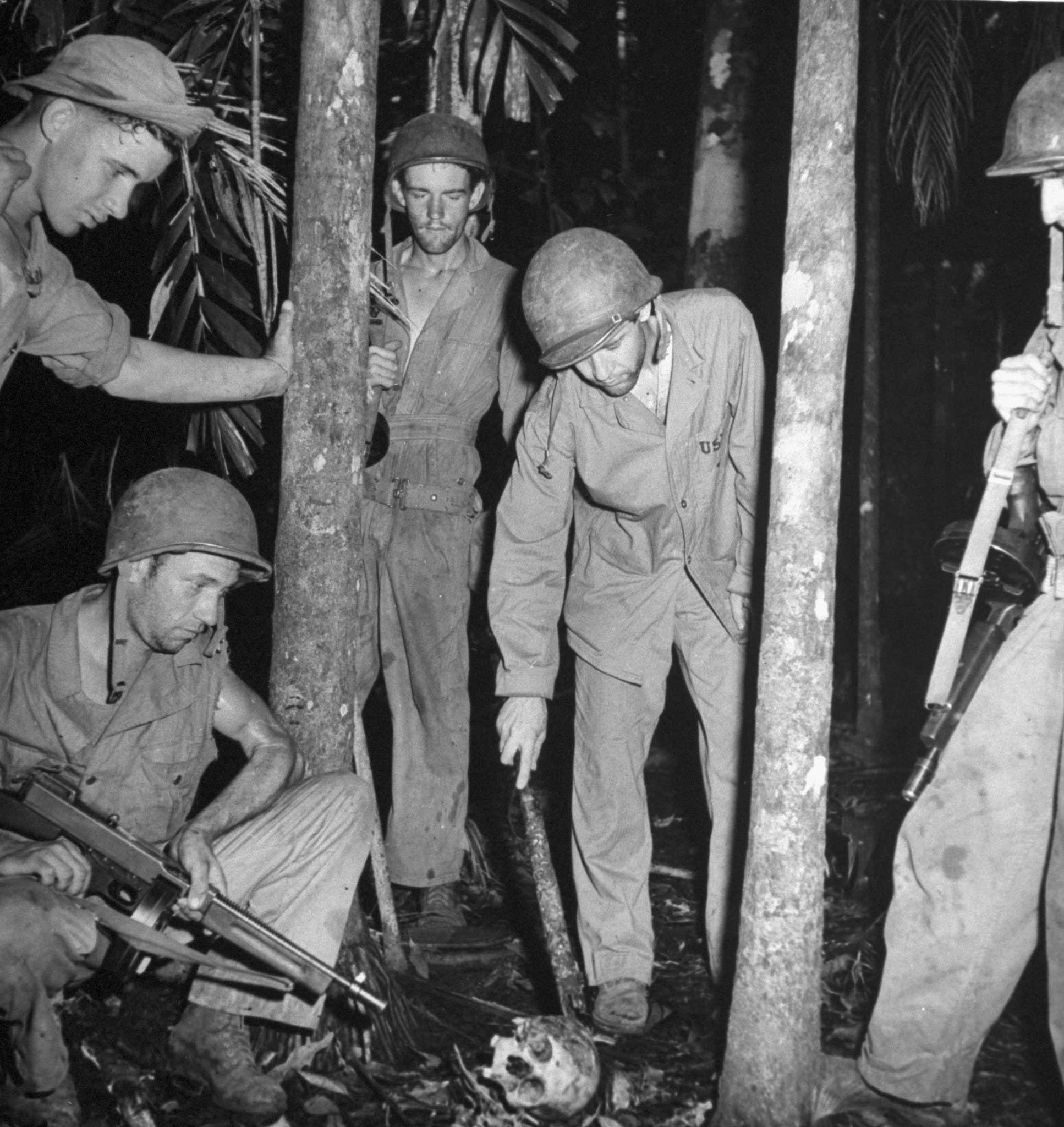 U.S. troops investigate an abandoned Japanese bivouac area, Guadalcanal, 1942.