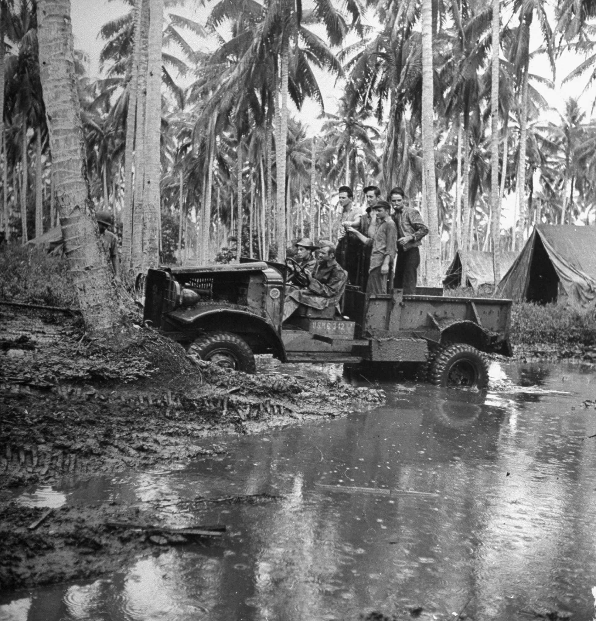 A Japanese truck captured by Marines is driven on a muddy road during the first Allied offensive in the Pacific, Guadalcanal, 1942.