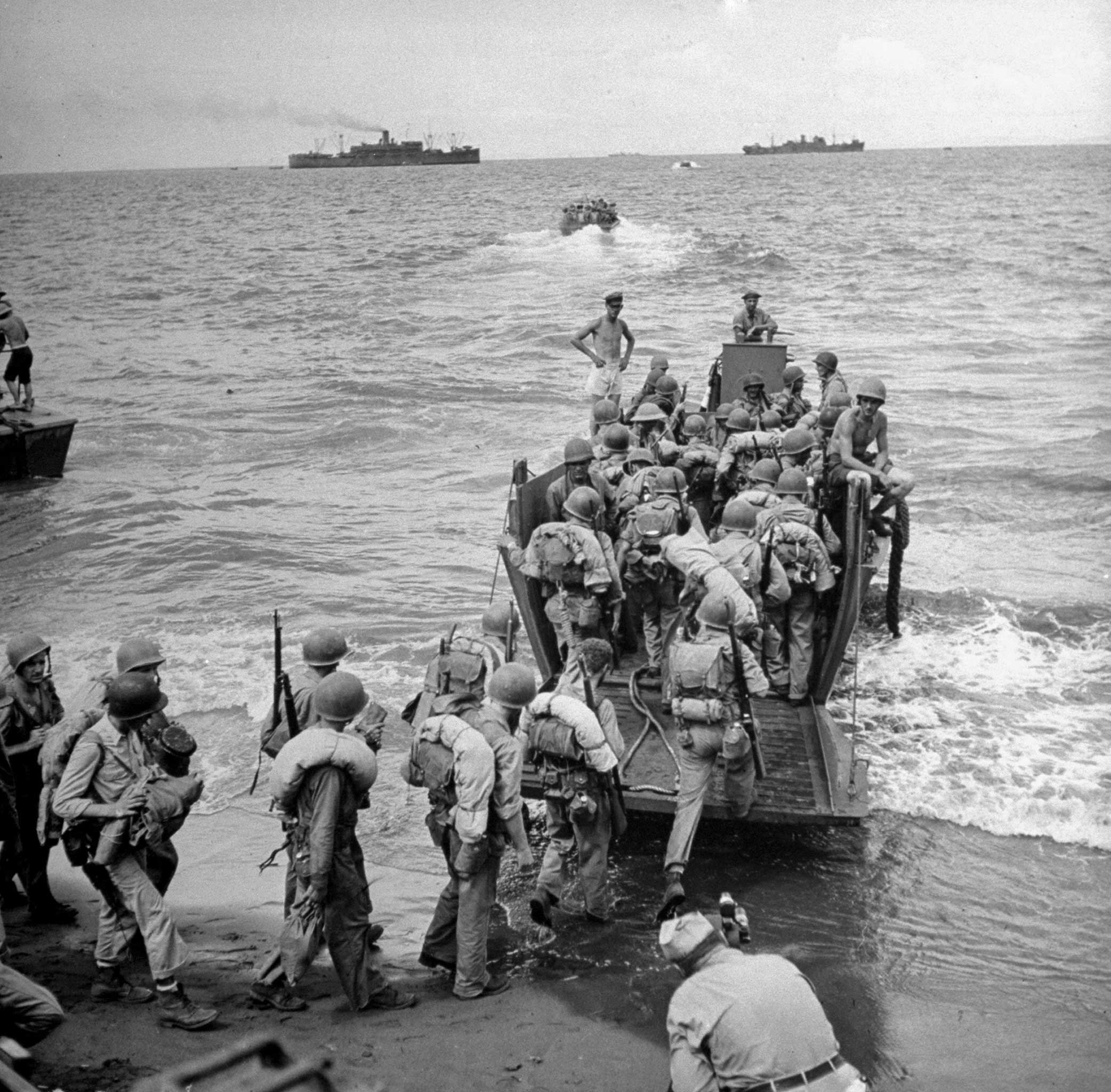 U.S. Marines board a landing craft for a ride to awaiting ships after turning over control of Guadalcanal to Army troops following four months of fighting the Japanese on the island.