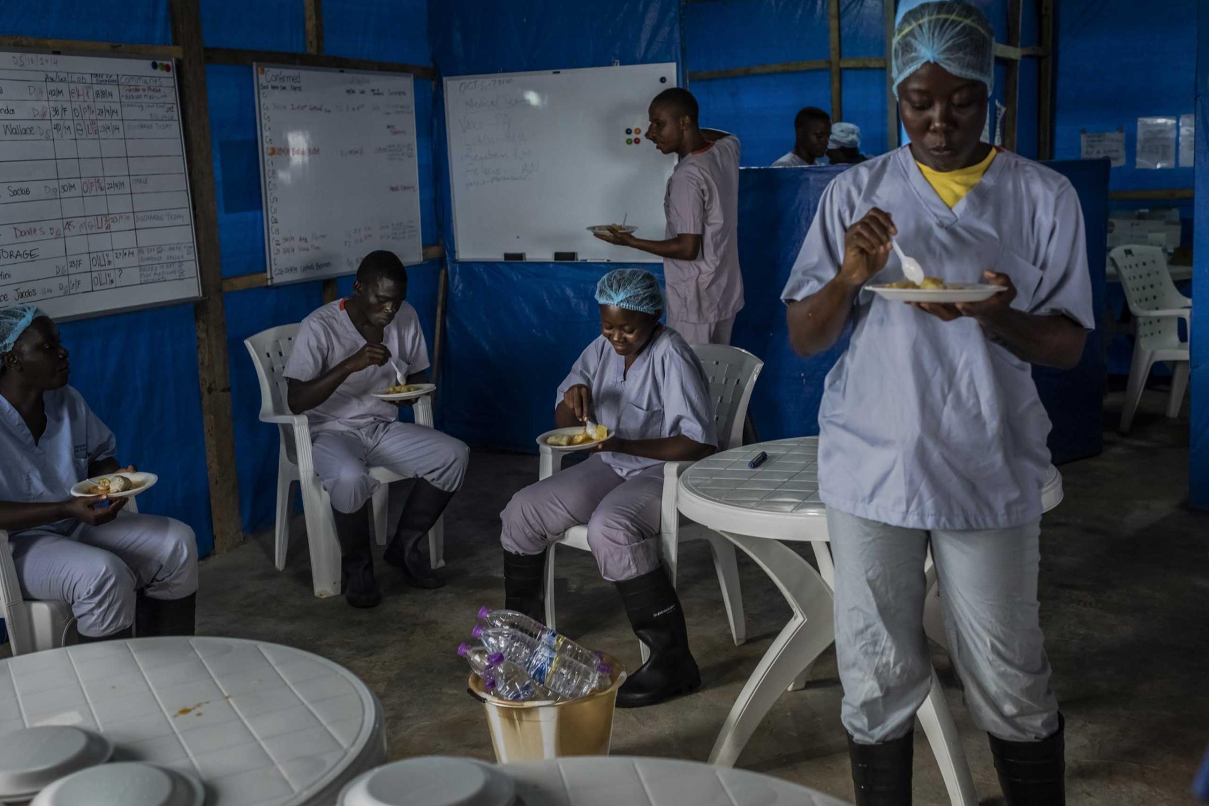 Health workers eat breakfast at the Bong County Ebola Treatment Unit near Gbarnga in rural Bong County, Liberia.