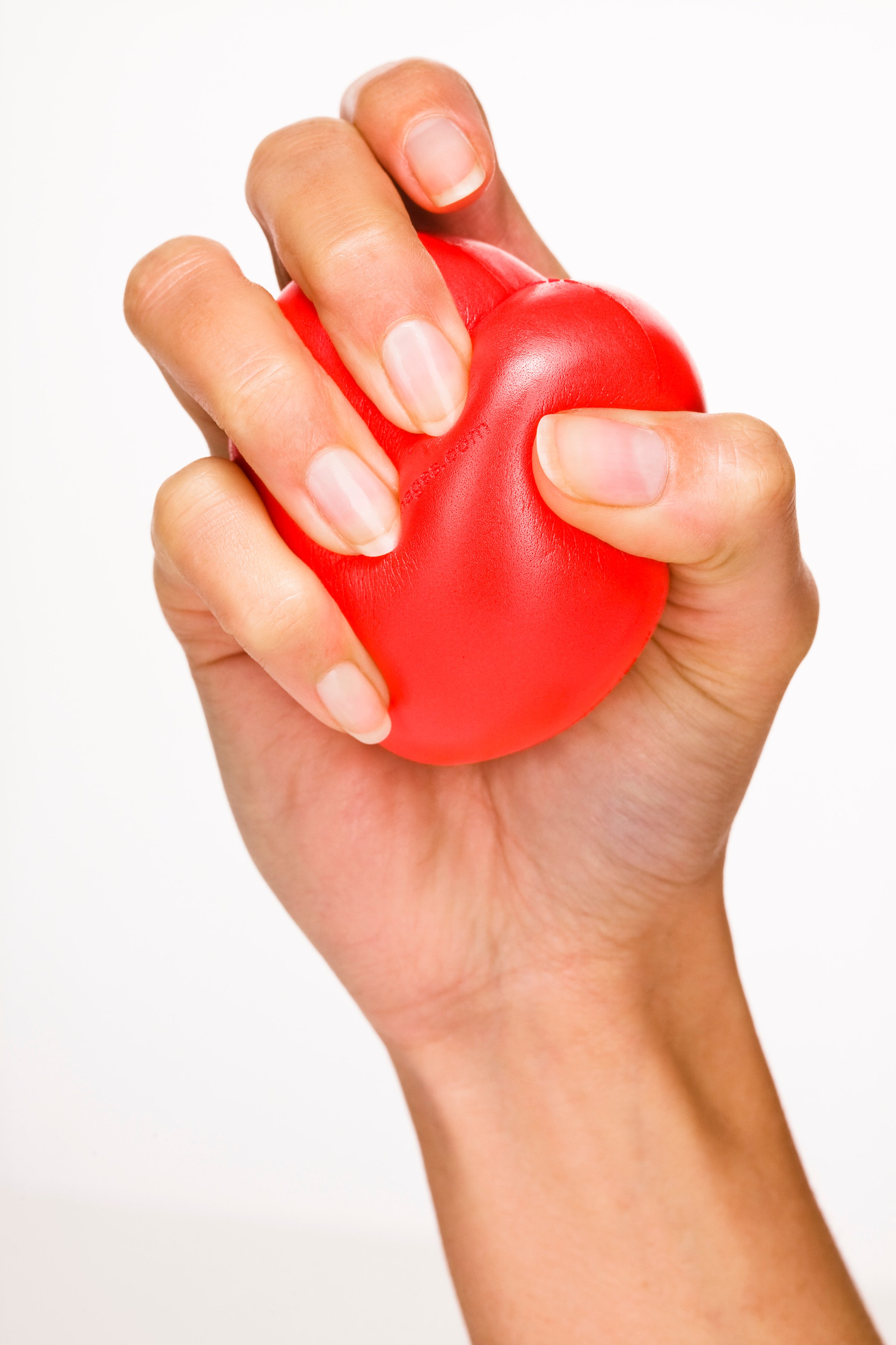 Woman's hand holding red plastic heart