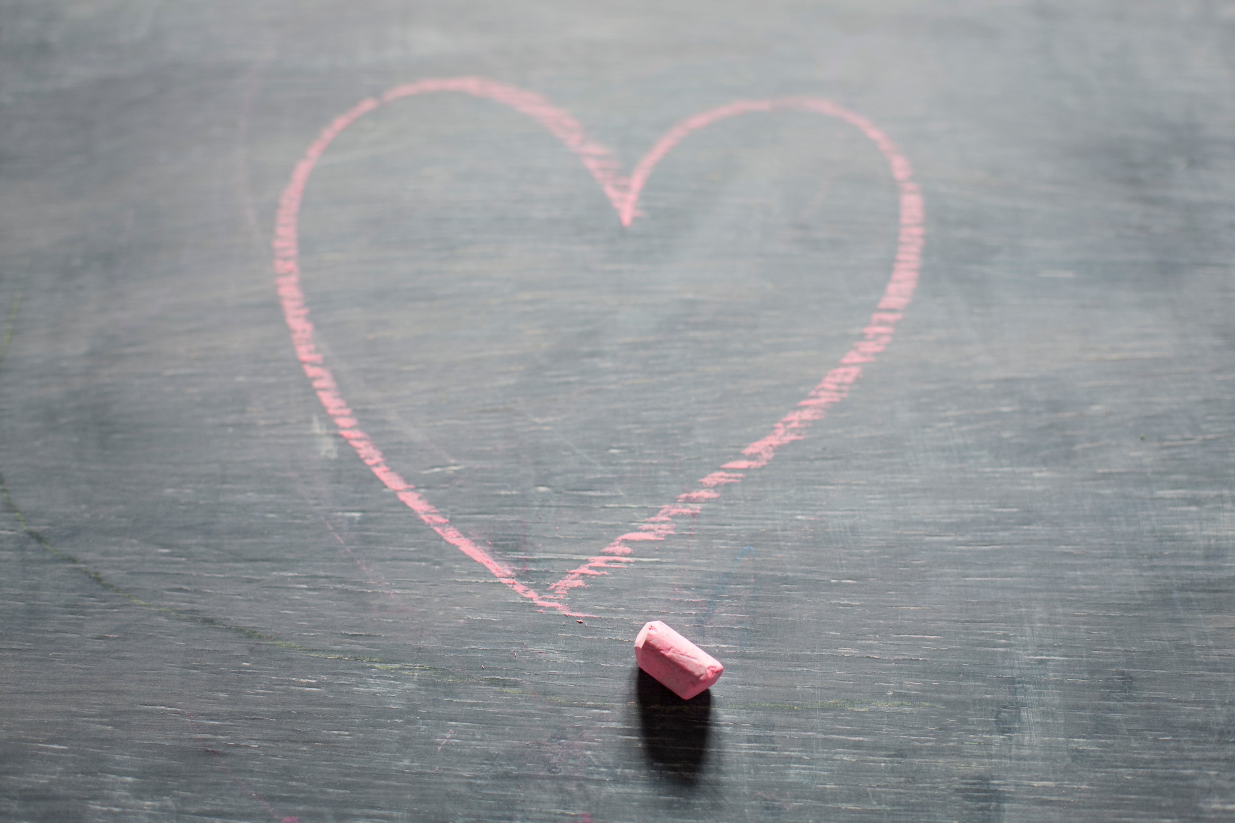 Chalk and heart shape on blackboard
