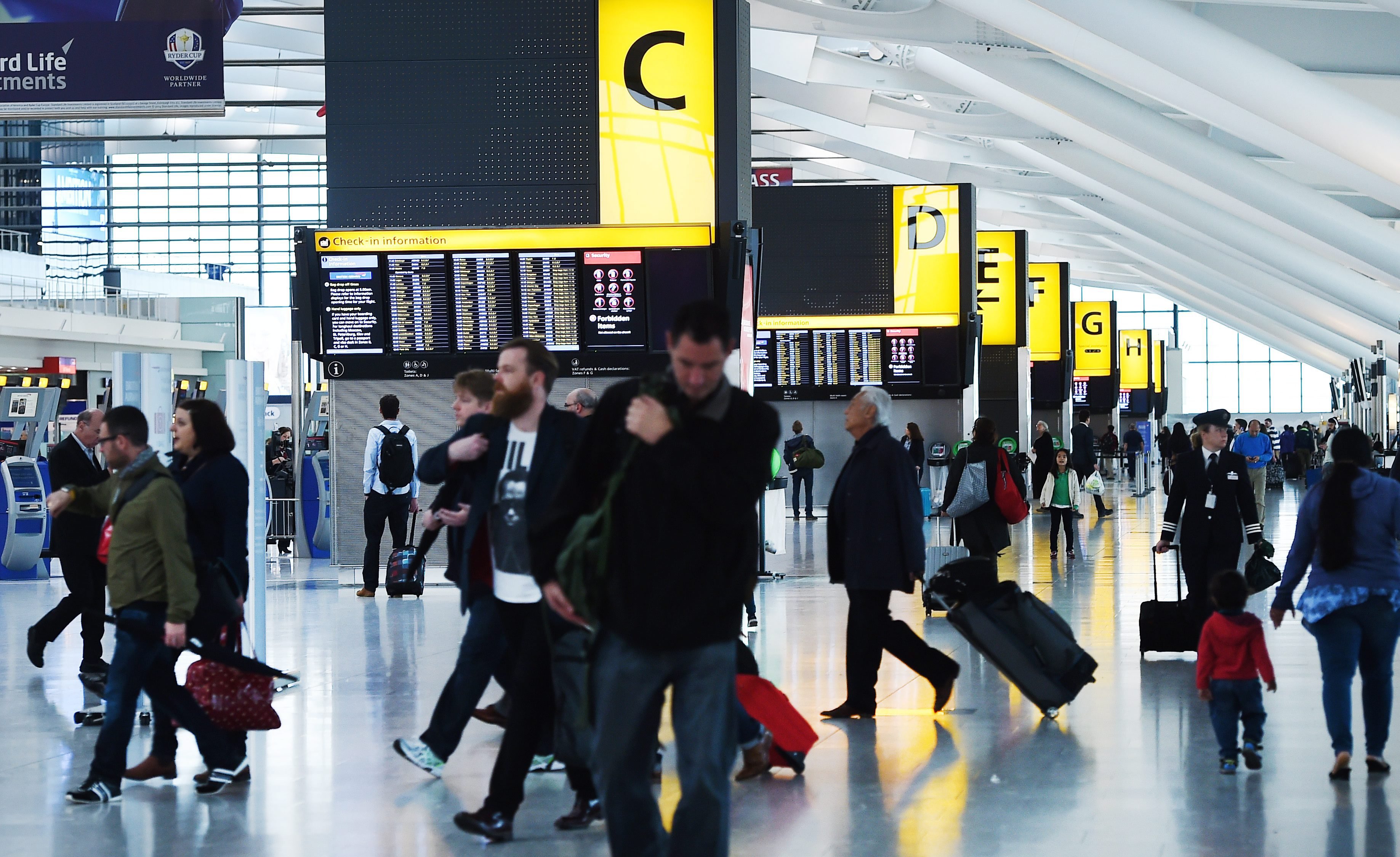 Passengers walk at Heathrow Airport in London on Oct. 14, 2014. (Andy Rain—EPA)