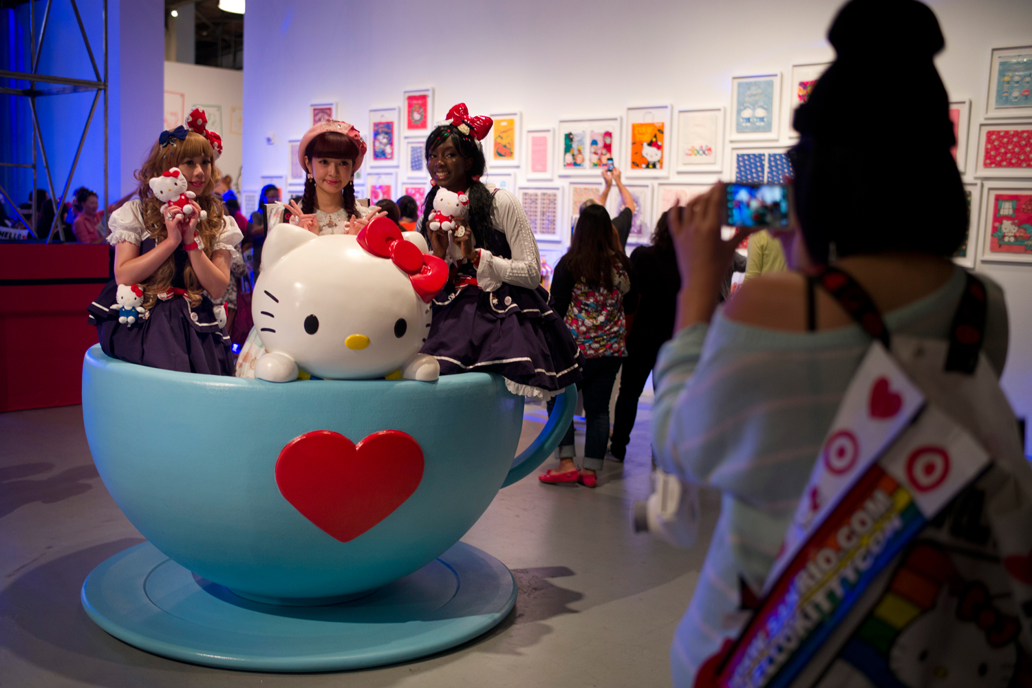 Hello Kitty fans pose for photos in a giant tea cup at the Hello Kitty Con, the first-ever Hello Kitty fan convention, held at the Geffen Contemporary at MOCA, Oct. 30, 2014, in Los Angeles (Jae C. Hong—AP)