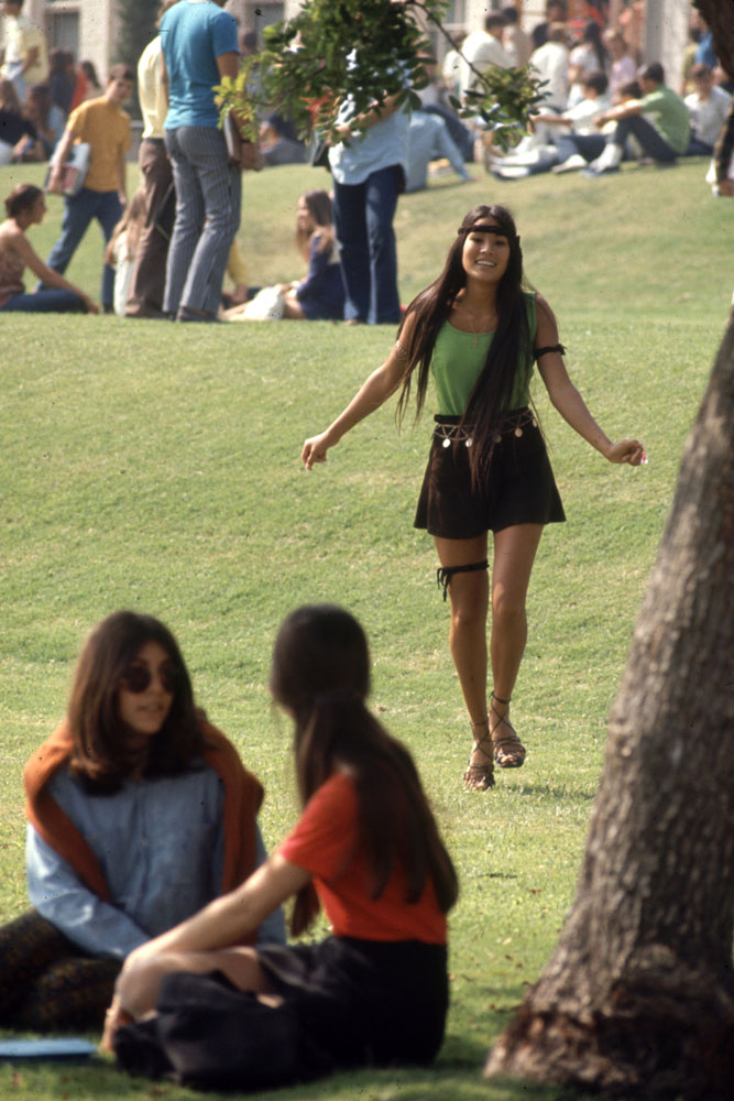 A Southern California high school student walks toward classmates while wearing the "Mini Jupe" skirt, 1969.