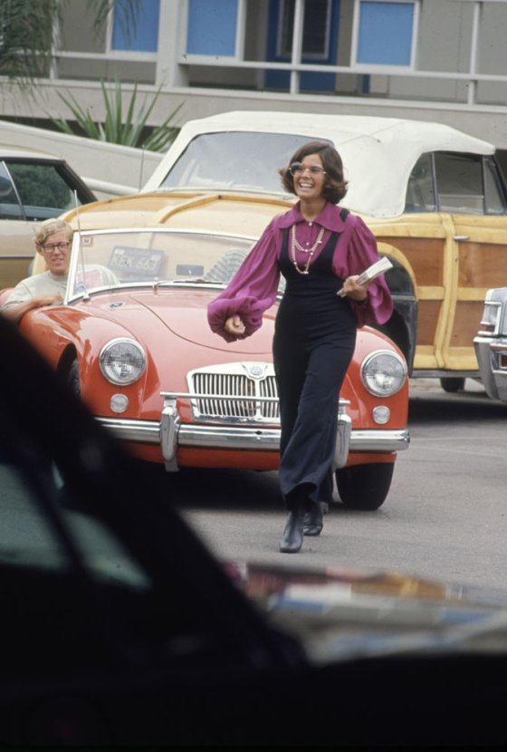 High schooler Lenore Reday stops traffic while wearing a bell-bottomed jump suit in Newport Beach, Calif., 1969.