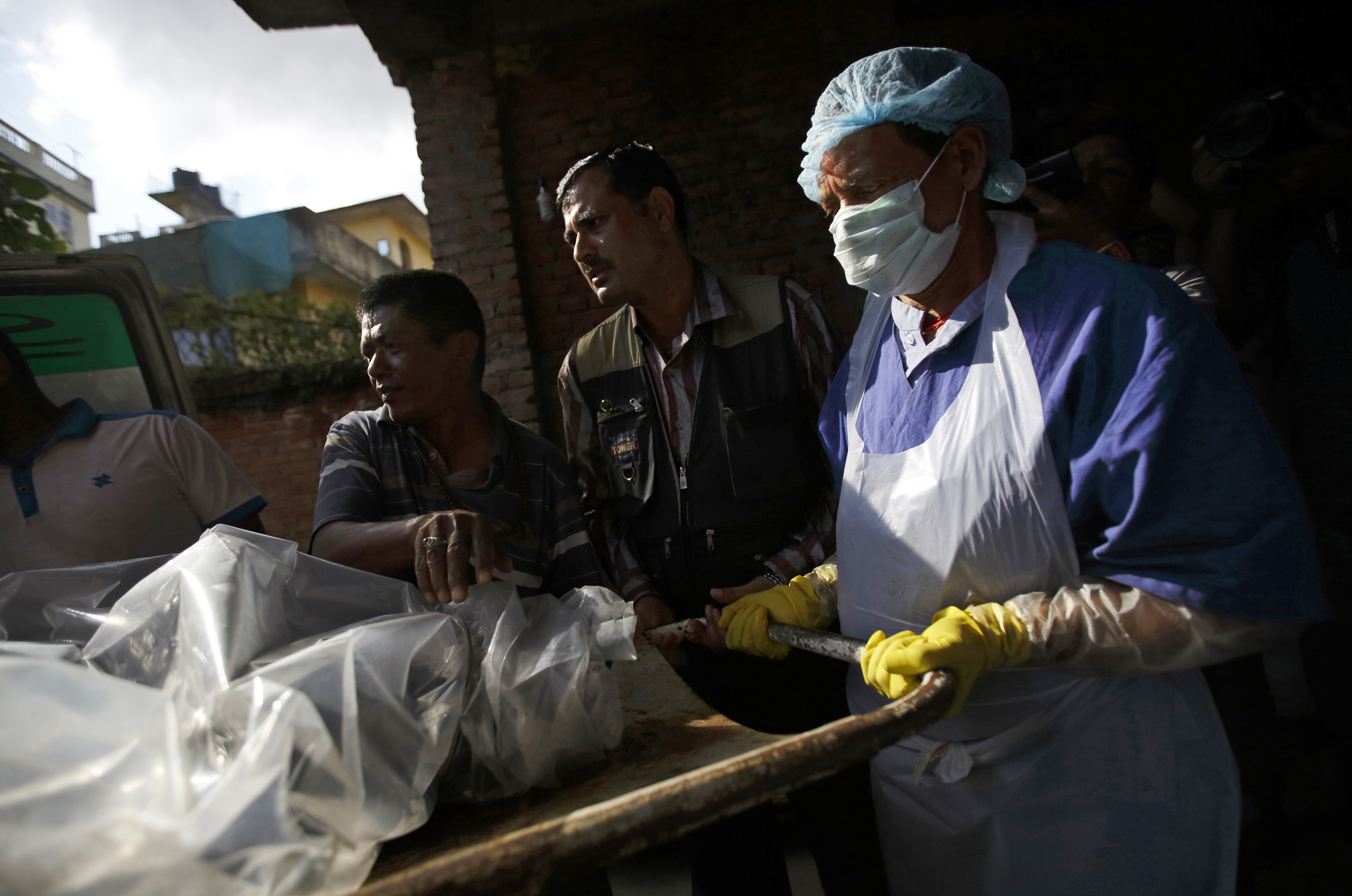 The body of a victim is moved from an ambulance to the morgue after it was brought back from Annapurna Region in Kathmandu October 17, 2014. (Navesh Chitrakar—Reuters)