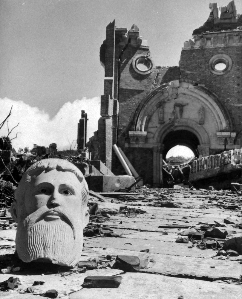 Bust in front of destroyed cathedral two miles from the atomic bomb detonation site, Nagasaki, Japan, 1945.