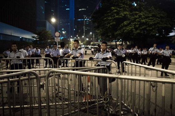 Police stand guard outside the government headquarters in Hong Kong on Oct. 2, 2014, as pro-democracy protesters remain gathered for the fifth day in a push for free elections of the city's leader.