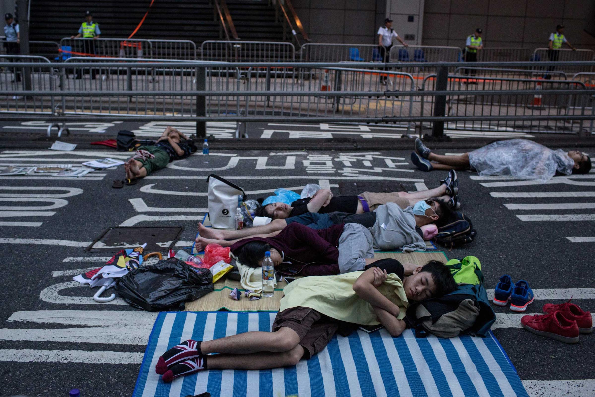 Protesters sleep on the road outside the Police Headquarters building on Oct. 2, 2014 in Hong Kong, Hong Kong.