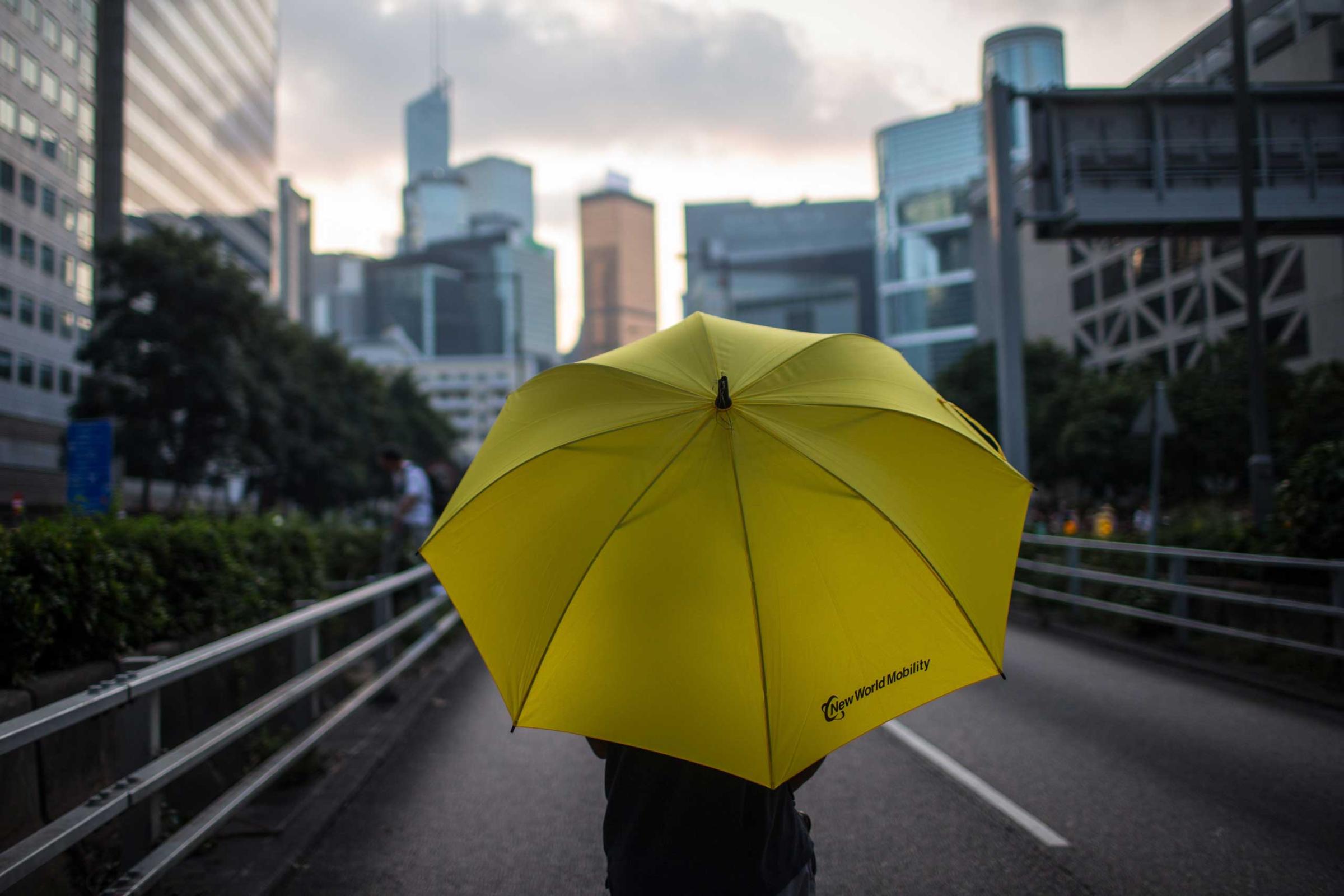 A protester holding an umbrella stands on the street close to the Hong Kong Government Complexon Oct. 1, 2014 in Hong Kong, Hong Kong.