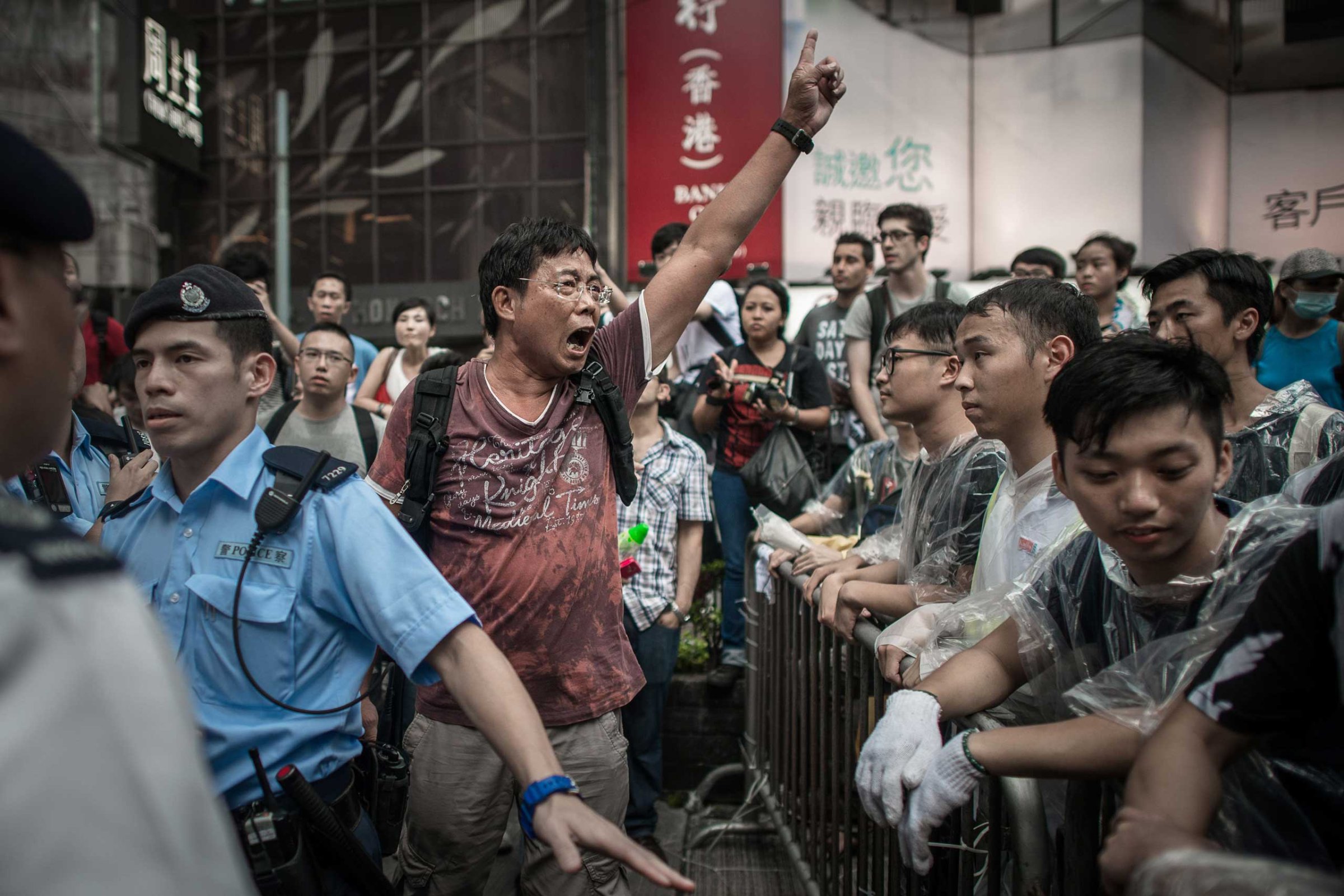 An anti-Occupy protester shouts at pro-democracy demonstrators in an occupied area of Hong Kong on Oct. 3, 2014.