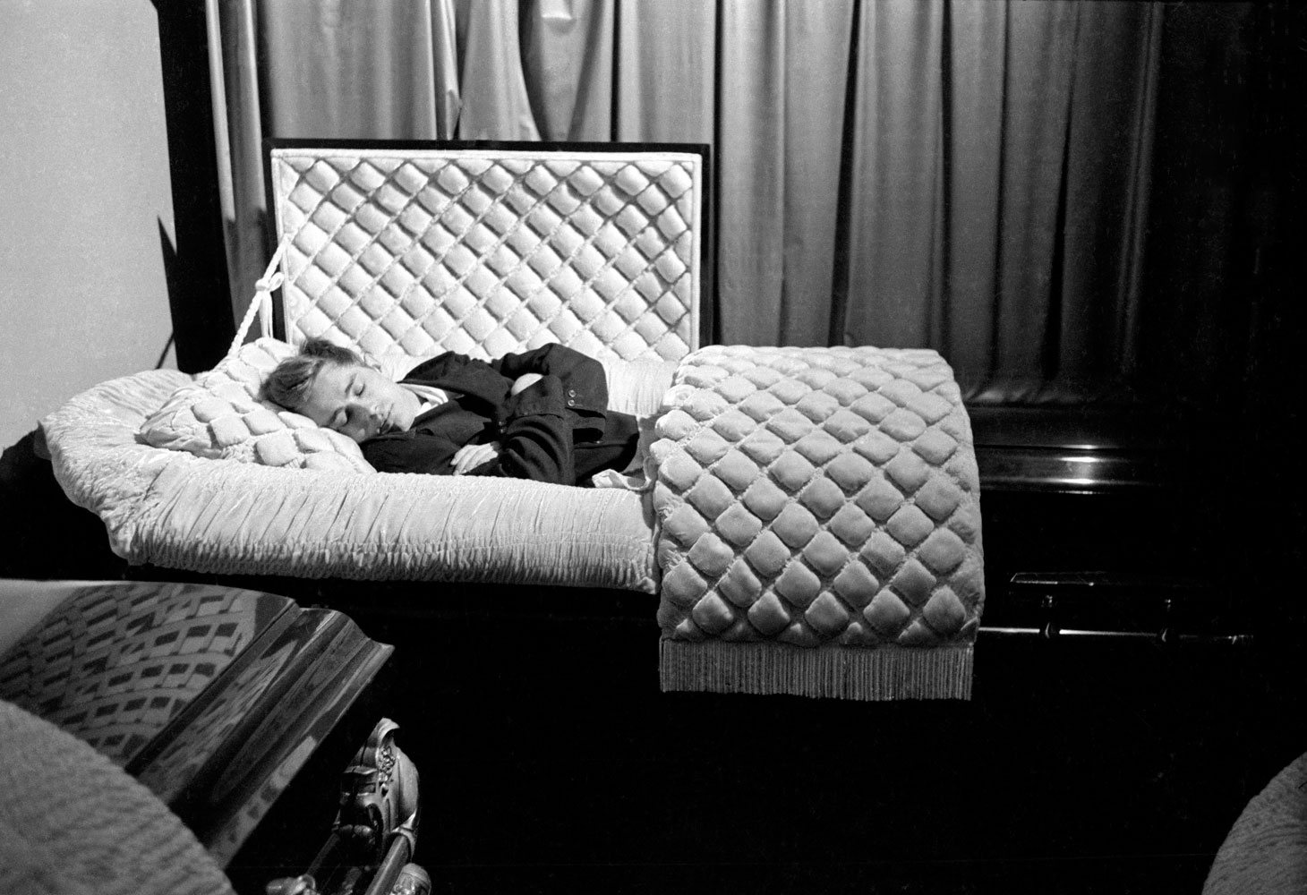 James Dean poses in a casket in a funeral parlor in Fairmount, Indiana, in 1955, seven months before he died.