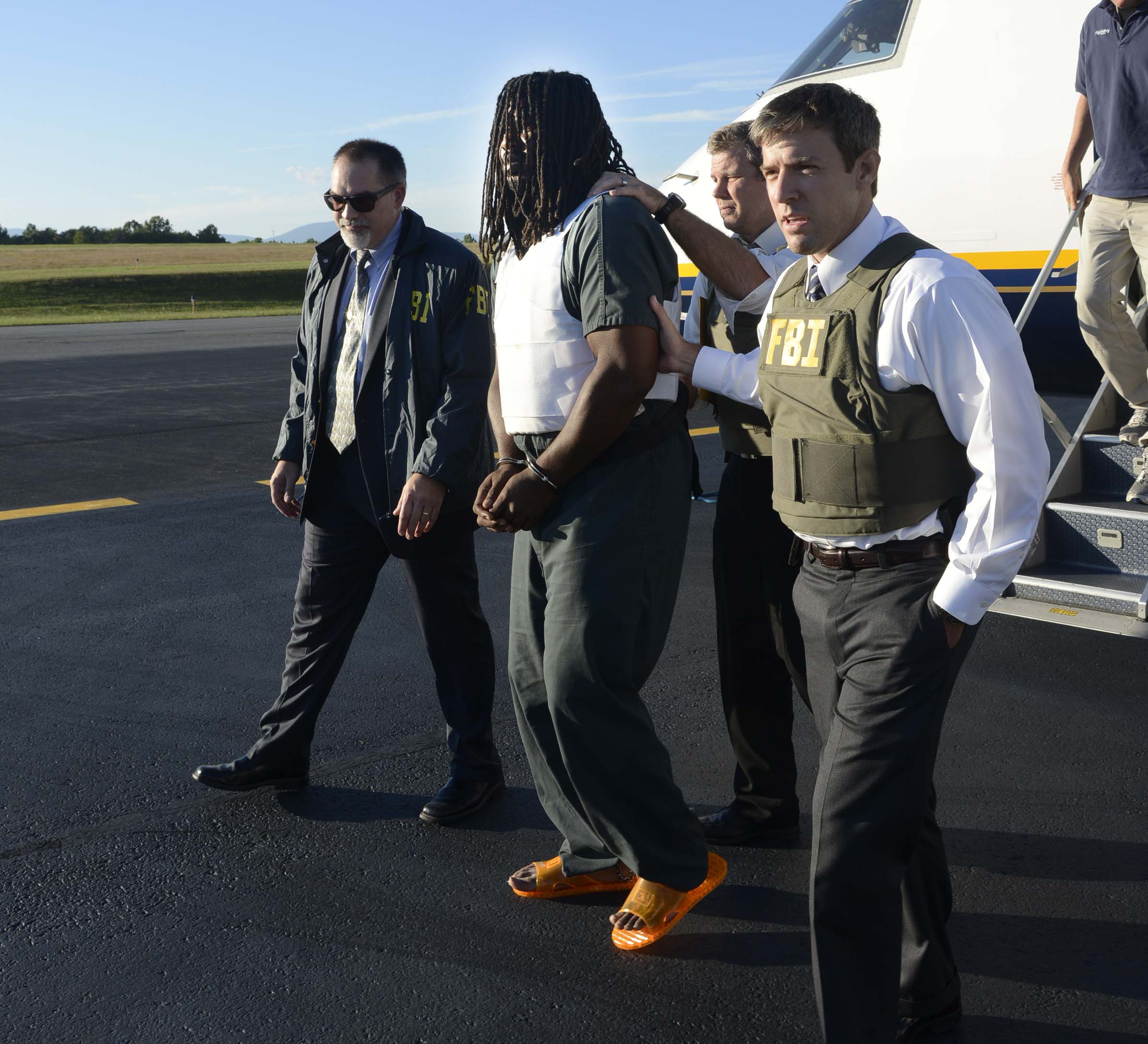 From left: FBI agents escort Jesse Matthew into the custody of the Charlottesville Police Department September 26, 2014 in Charlottesville, Virginia.