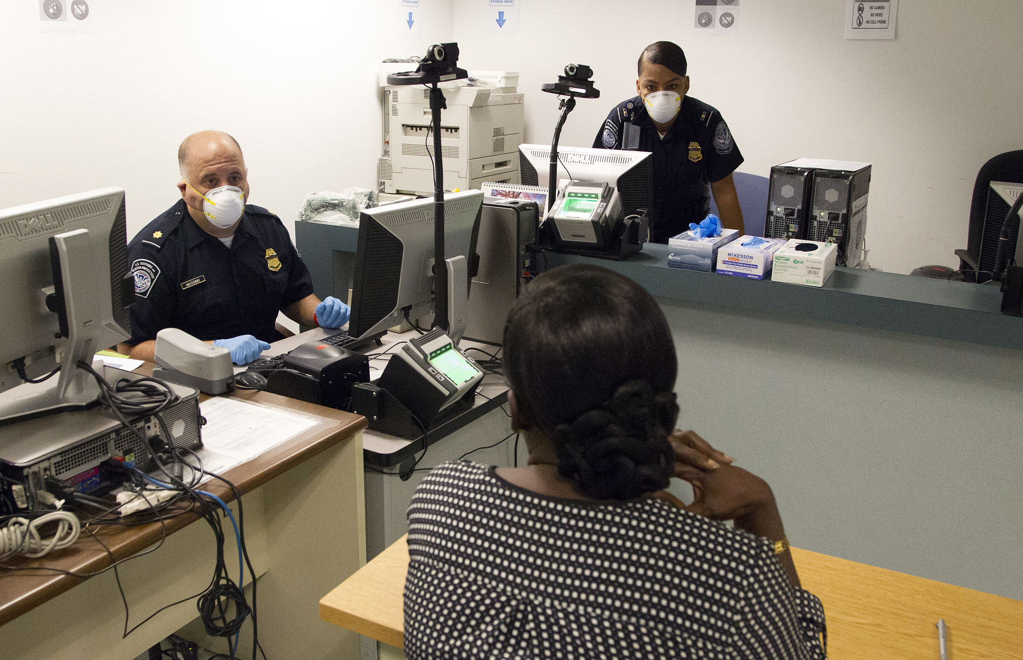 IINTERNATIONAL PASSENGERS BEING SCREENED FOR MEDICAL CONDITIONS RELATED TO EBOLA AT  THE CHICAGO INTERNATIONAL AIRPORT BY MEMBERS OF THE US CUSTOMS AND BOARDER PATROL AND A US COAST GUARD MEDICAL TEAM, BOTH PART OF THE US DEPARTMENT HOMELAND SECURITY. THE