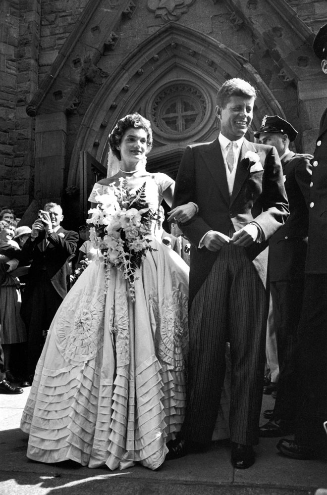"Jacqueline Bouvier in gorgeous Battenburg wedding dress with her husband Sen. John Kennedy as they stand in front of church after wedding ceremony."