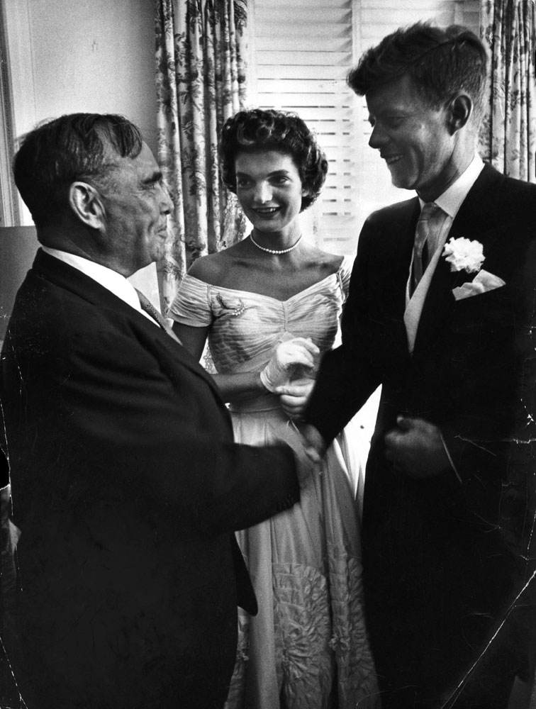 "Speaker Joe Martin of House of Representatives congratulates bride and bridegroom in receiving line. Kennedy served three terms in the House."