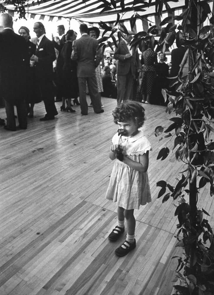 A girl with a flower at John and Jacqueline Kennedy's wedding reception, Newport, R.I., Sept. 12, 1953.