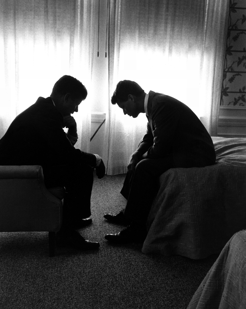 Senator and presidential candidate John F. Kennedy (left) and his campaign manager, Robert Kennedy, confer in a hotel room during the Democratic National Convention, Los Angeles, July 1960.