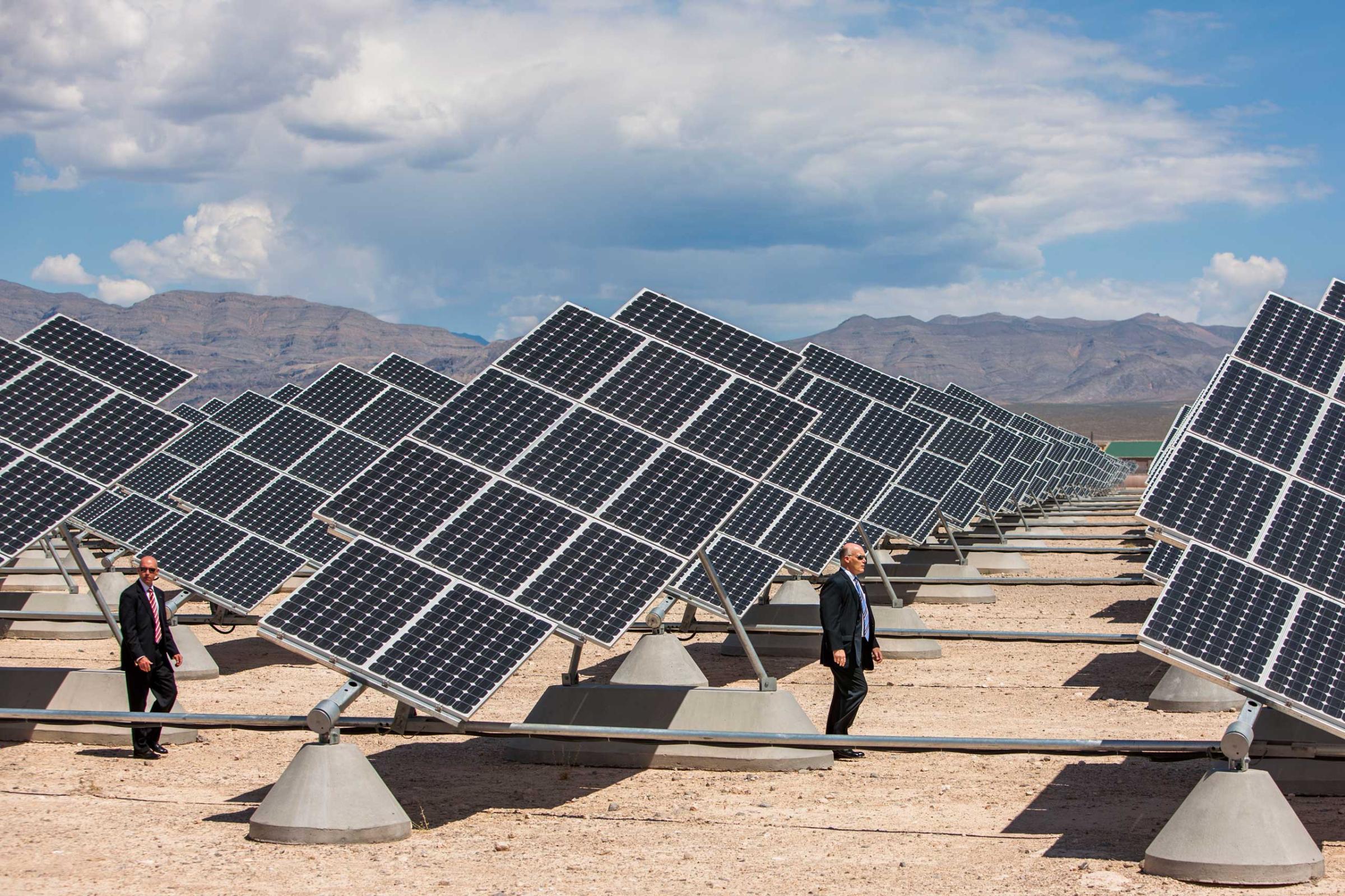 President Barack Obama and Senate Majority Leader Harry Reid of Nev., are accompanied by Col. Howard Belote as they look at solar panels at Nellis Air Force Base in NevadaPhoto by Brooks Kraft/Corbis