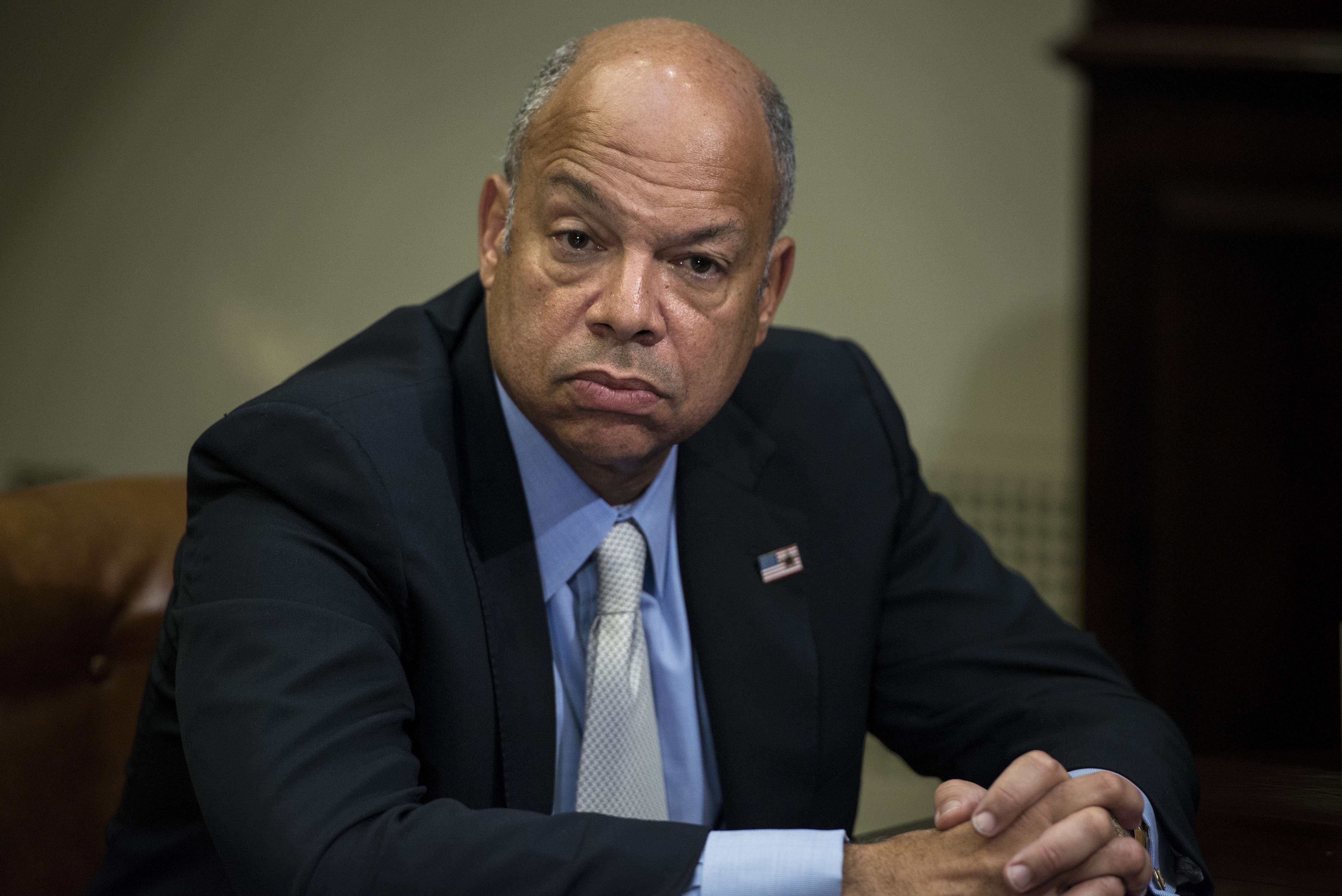 US Secretary of Homeland Security Jeh Johnson listens while US President Barack Obama makes a statement to the press after a meeting in the Roosevelt Room of the White House on Oct. 6, 2014 in Washington, DC.