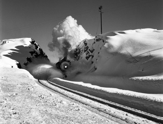 Southern Pacific locomotive using a plow to clear snow from tracks in Donner Pass, five miles west of Soda Springs, Calif., 1949.