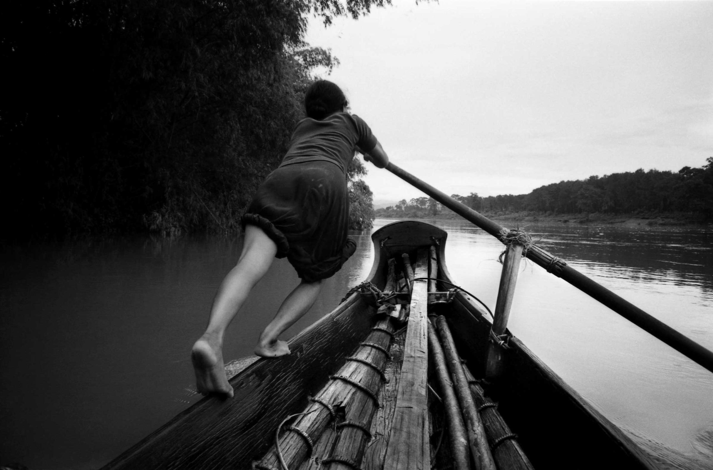 A boat girl rows a sampan across the Perfume River, Vietnam, 1961.
