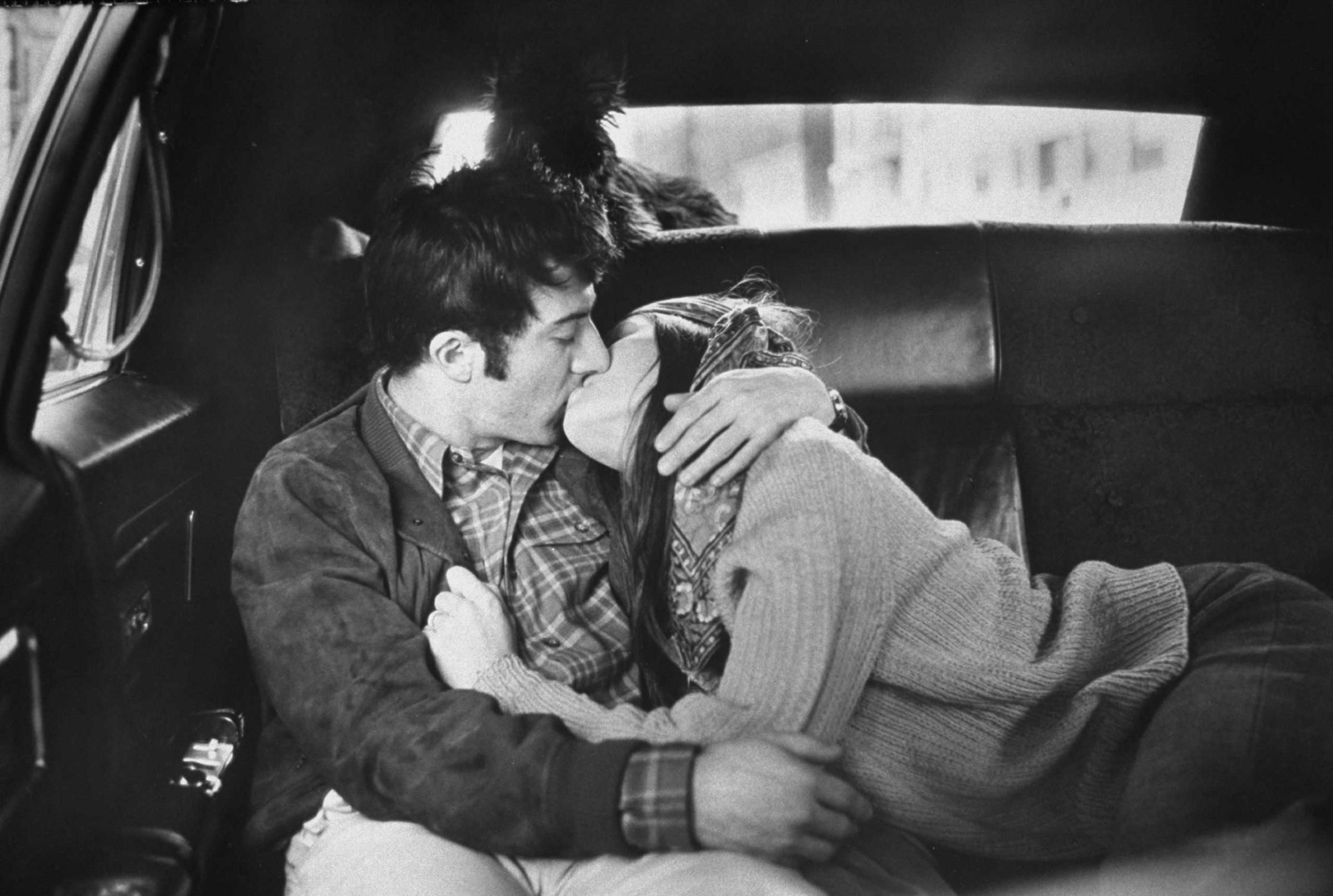 Dustin Hoffman kisses his wife, Anne Byrne, in the back of a taxi, New York, 1969.