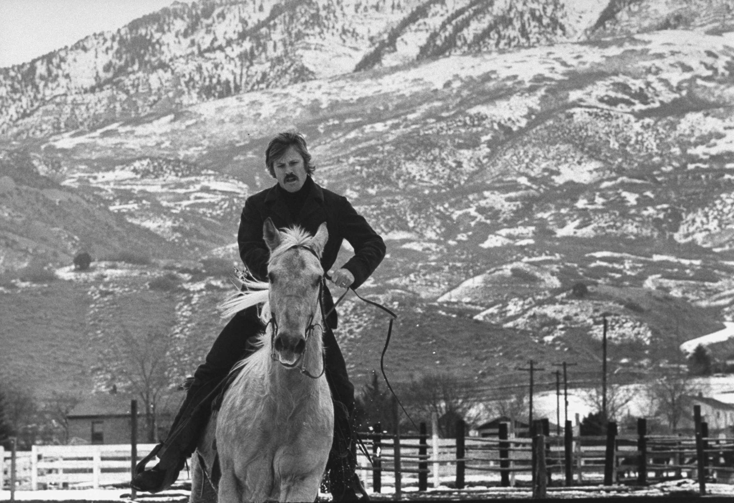 Robert Redford exercises one of his eight saddle horses on his ranch in Utah, 1970.