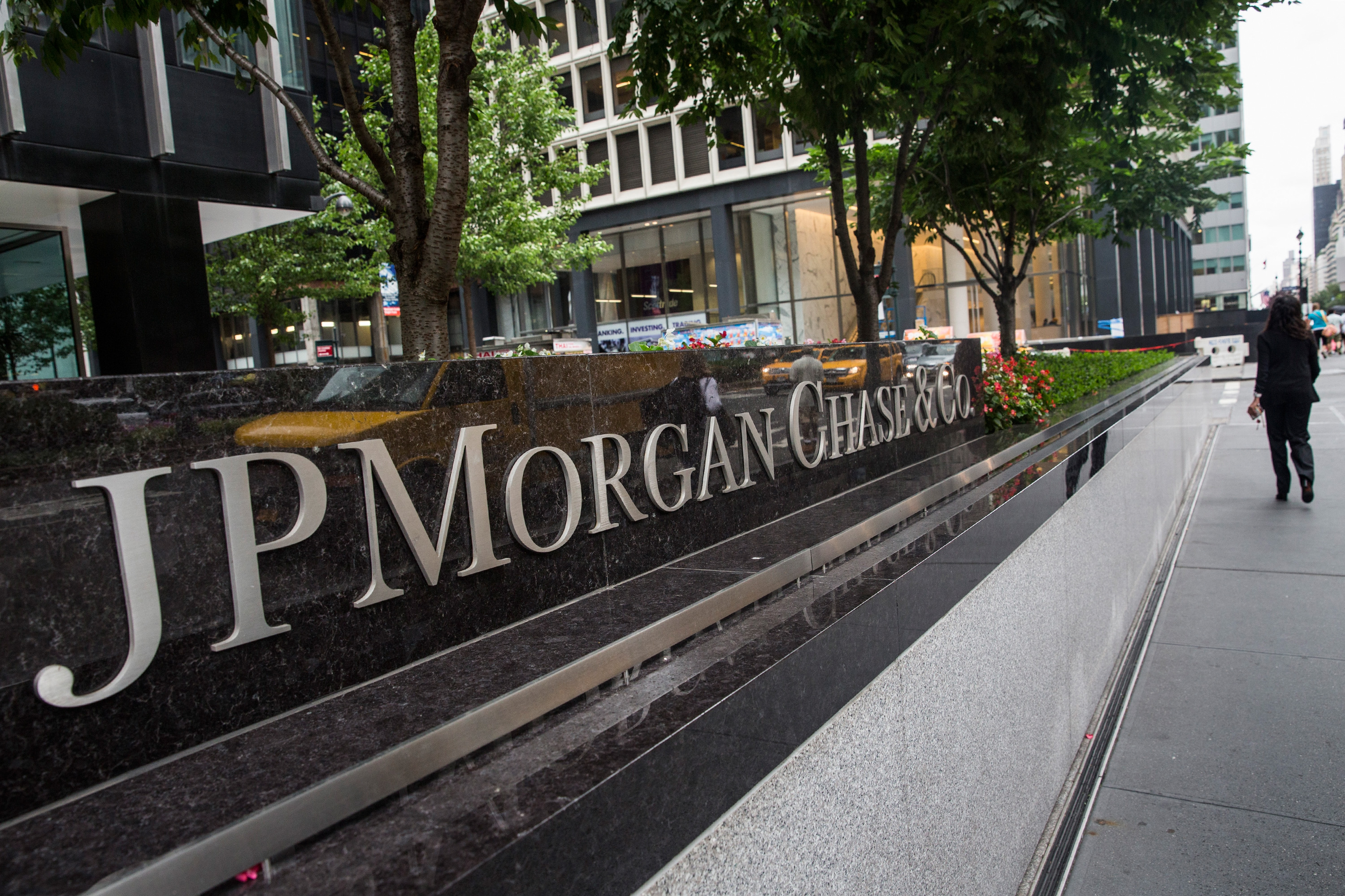 A woman walks past JP Morgan Chase's corporate headquarters on August 12, 2014 in New York City. (Andrew Burton&mdash;Getty Images)