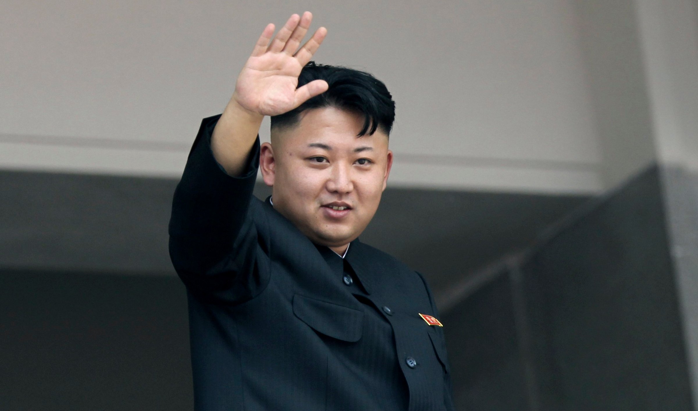Kim Jong Un waves to spectators and participants of a mass military parade celebrating the 60th anniversary of the Korean War armistice in Pyongyang on July 27, 2013.