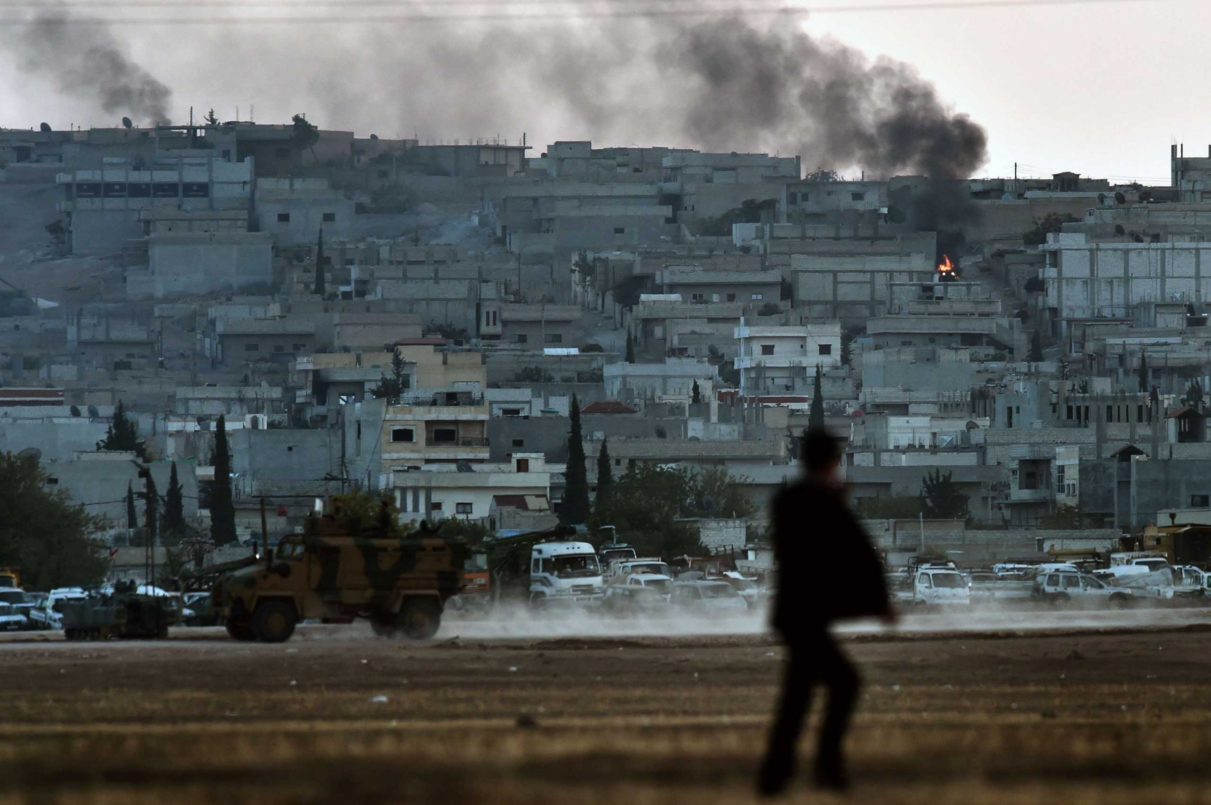 Smoke rises from the city centre of the Syrian town of Ain al-Arab, known as Kobani by the Kurds, as seen from the Turkish-Syrian border during heavy fighting, in the southeastern town of Suruc, Sanliurfa province, Turkey, on Oct. 7, 2014.