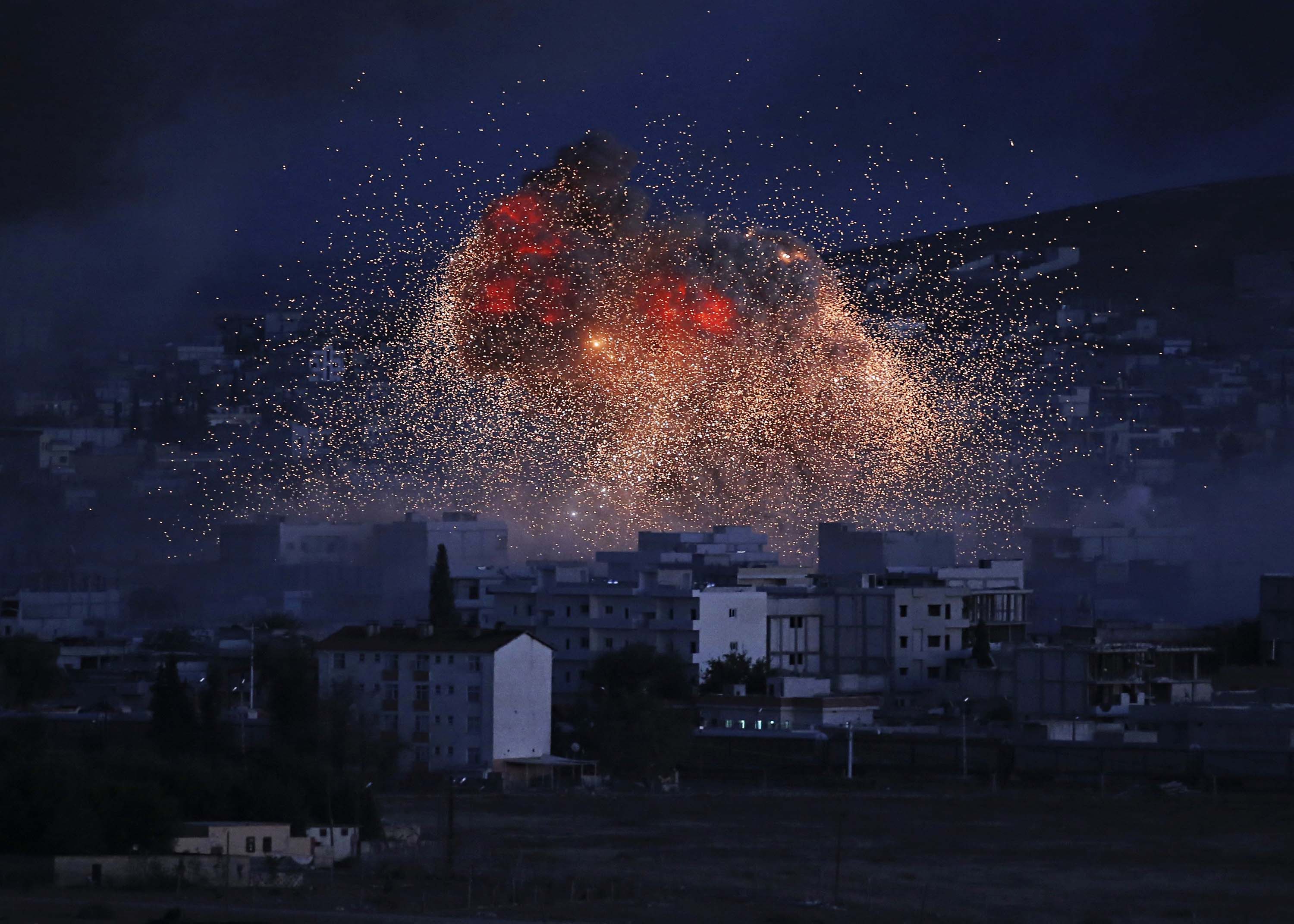 A U.S.-led coalition air strike over the town of Kobani, where Kurds are battling ISIS (Lefteris Pitarakis—AP)