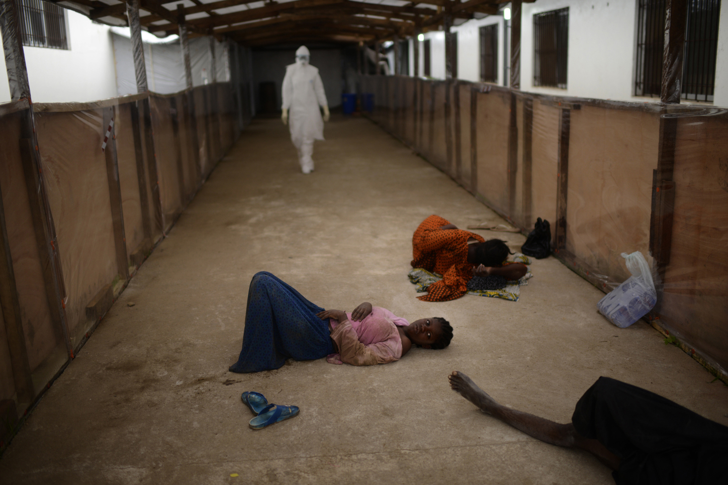 Critically ill patients wait for beds to be prepared for them at Island Clinic, Monrovia, Liberia, Sept. 24, 2014.